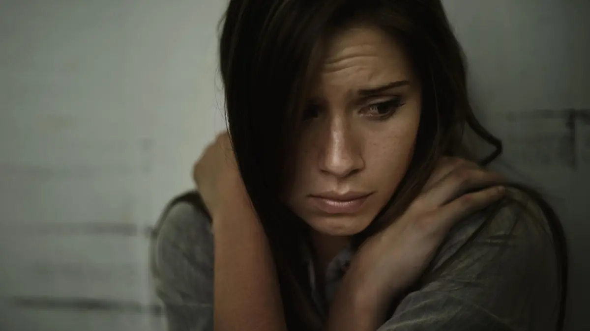 A young woman looking anxious and fearful