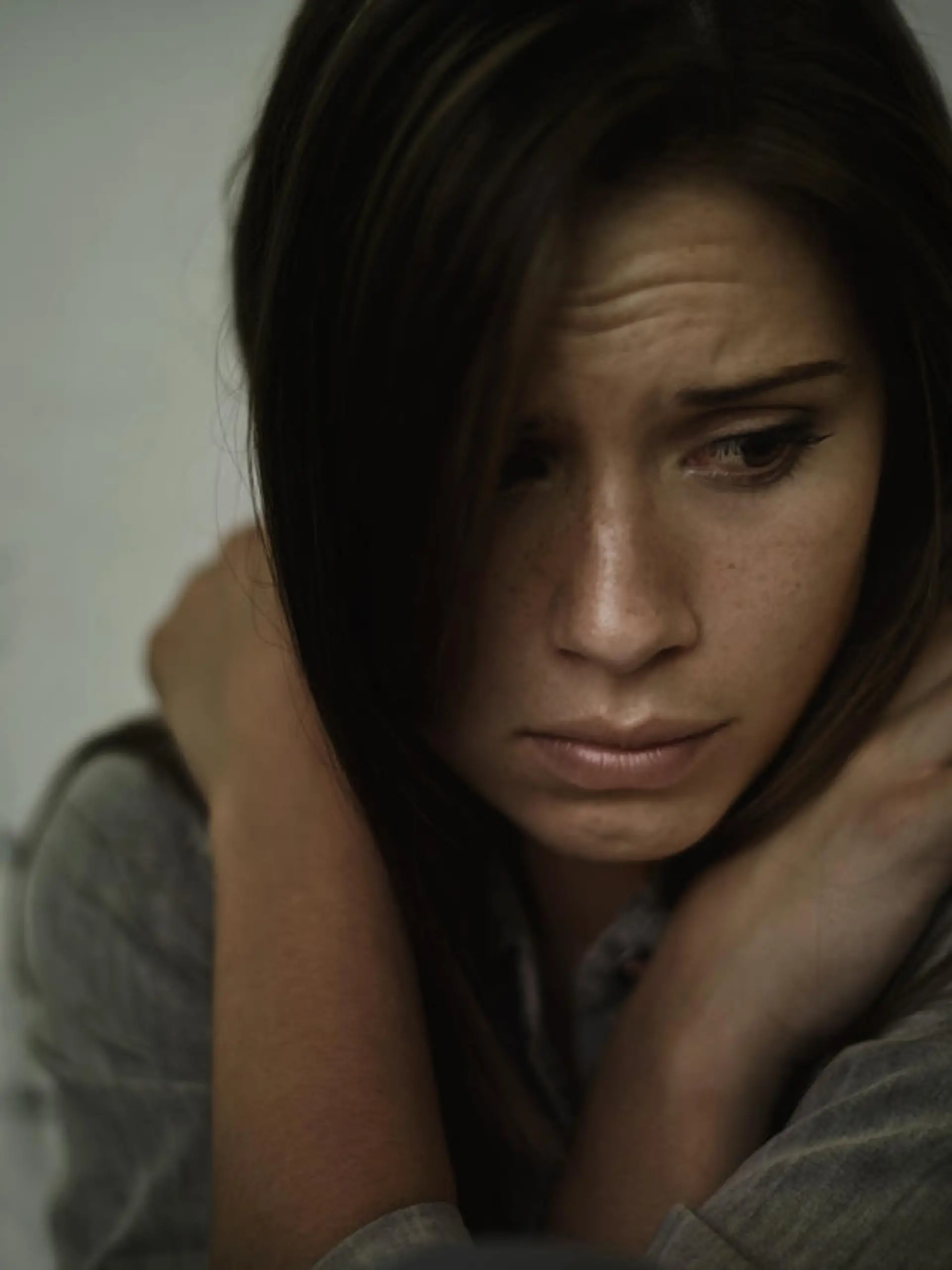 A young woman looking anxious and fearful