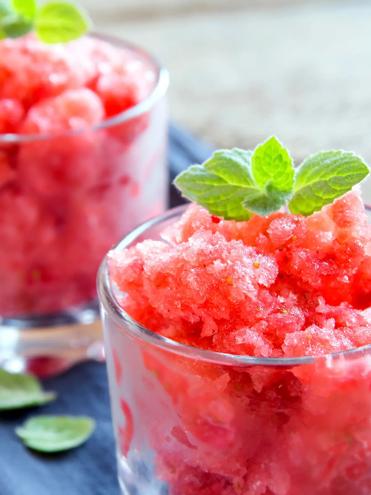 Strawberry granita with mint (frozen dessert) in portion glasses close up