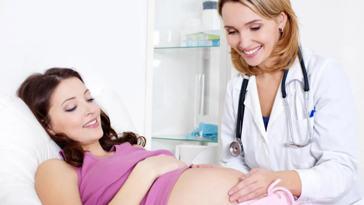 Doctor Care about young pregnant woman in hospital - indoors