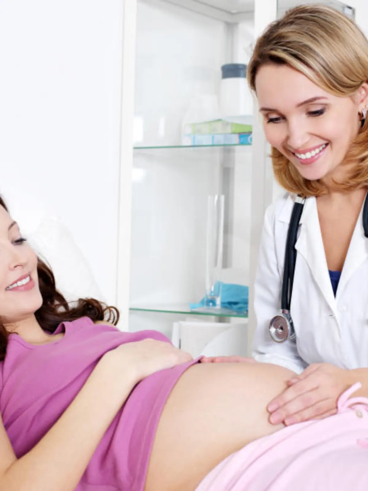 Doctor Care about young pregnant woman in hospital - indoors