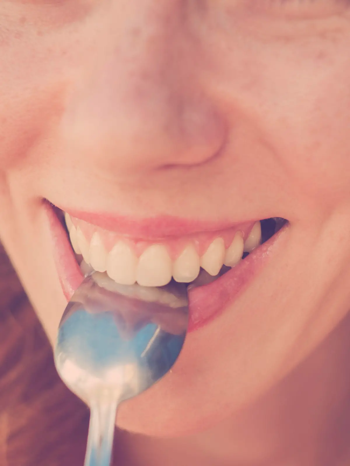 Beautiful Pin-Up Girl eating dessert, biting on a spoon. Vintage, retro styled imagery