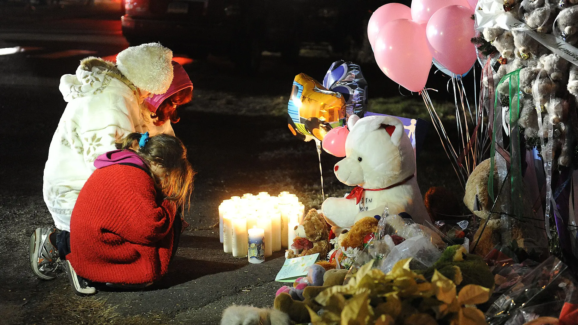 People lights candles at the entrance to the street leading to the Sandy Hook Elementary School on December 15, 2012 in Newtown, Connecticut. Twenty six people were shot dead, including twenty children, after a gunman identified as Adam Lanza opened fire in the school. Lanza also reportedly had committed suicide at the scene. A 28th person, believed to be Nancy Lanza was found dead in a house in town, was also believed to have been shot by Adam Lanza. Photo by Olivier Douliery/ABACAUSA.com