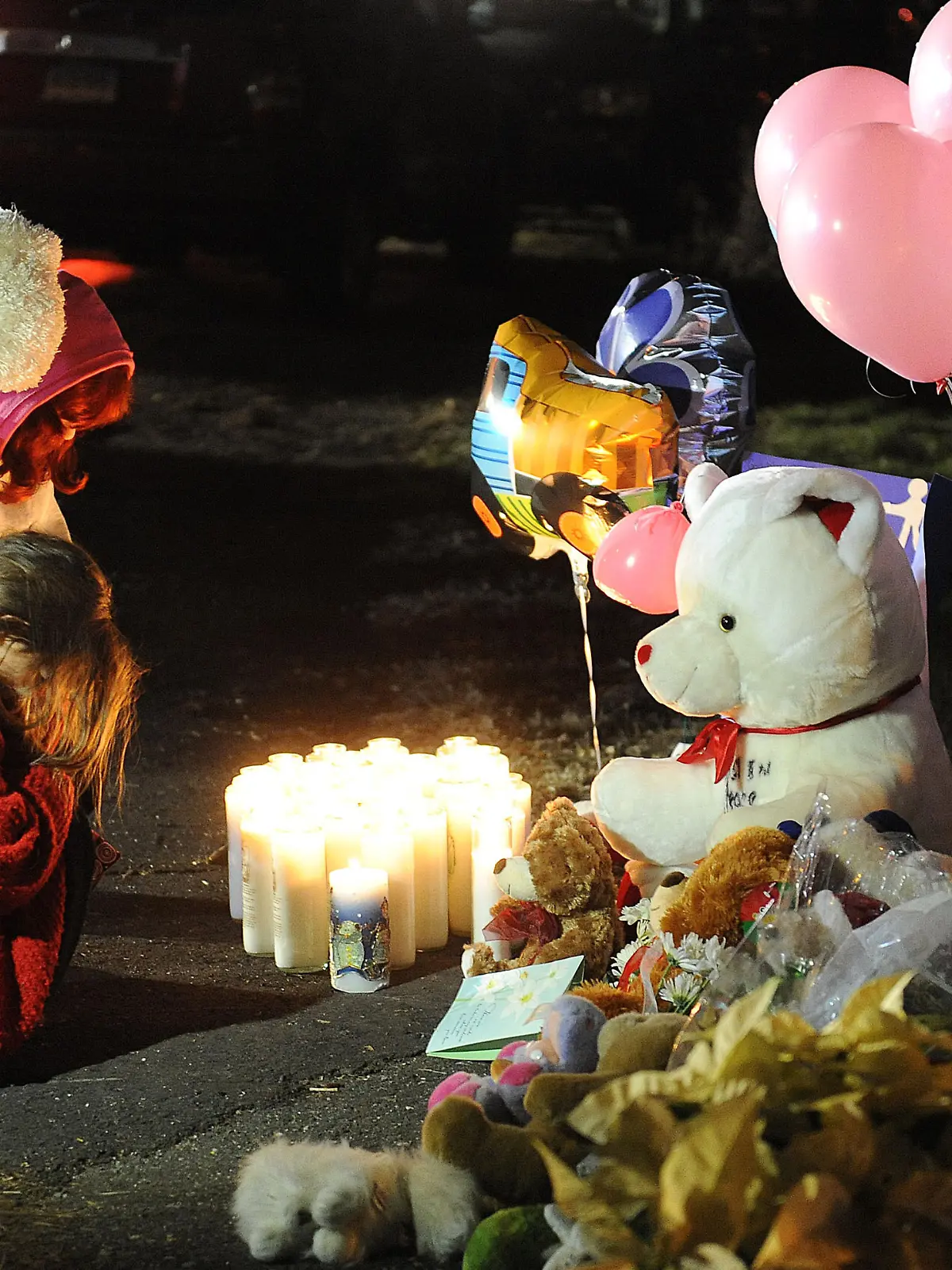 People lights candles at the entrance to the street leading to the Sandy Hook Elementary School on December 15, 2012 in Newtown, Connecticut. Twenty six people were shot dead, including twenty children, after a gunman identified as Adam Lanza opened fire in the school. Lanza also reportedly had committed suicide at the scene. A 28th person, believed to be Nancy Lanza was found dead in a house in town, was also believed to have been shot by Adam Lanza. Photo by Olivier Douliery/ABACAUSA.com