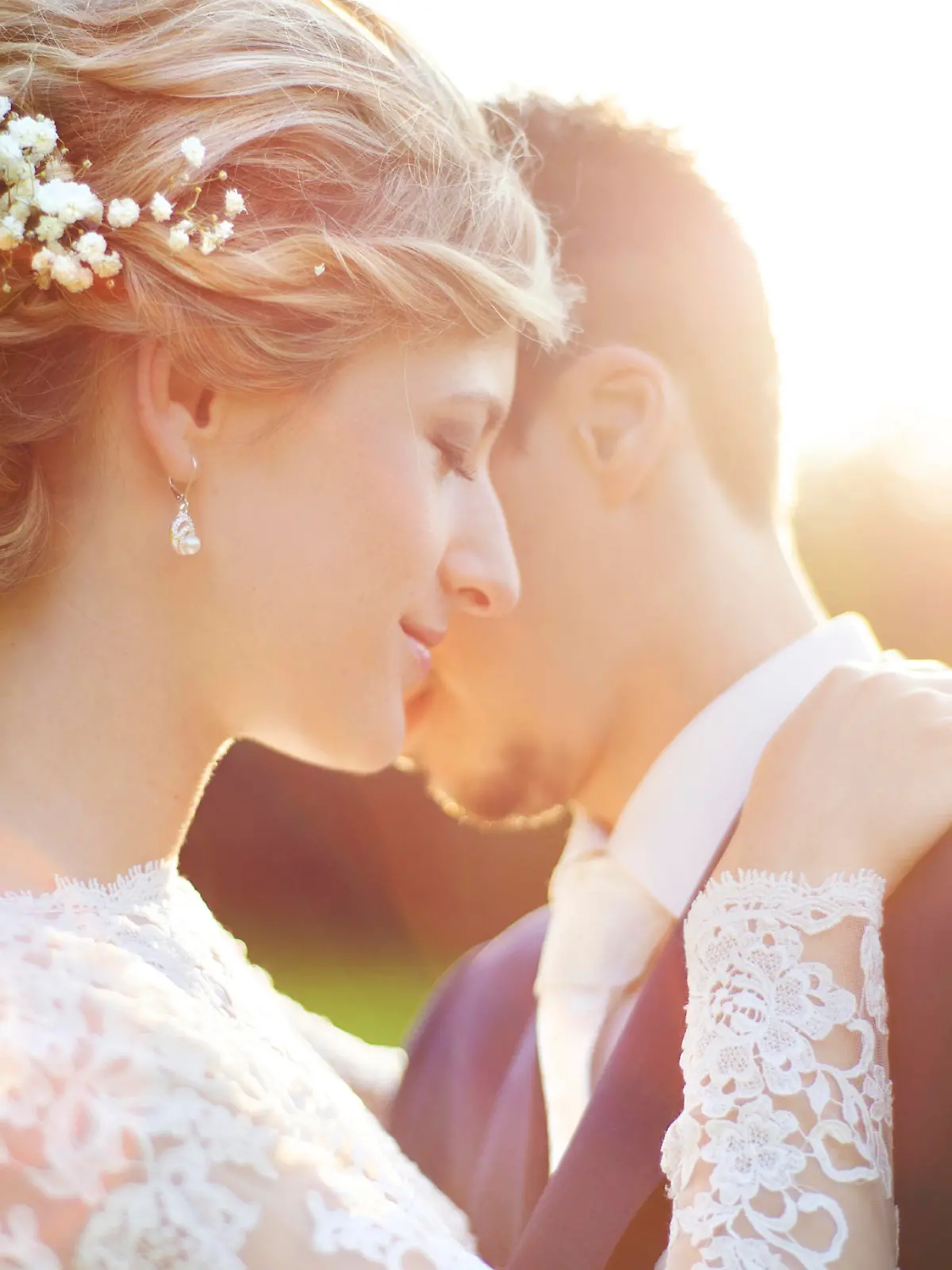 Young wedding couple enjoying romantic moments outside on a summer meadow