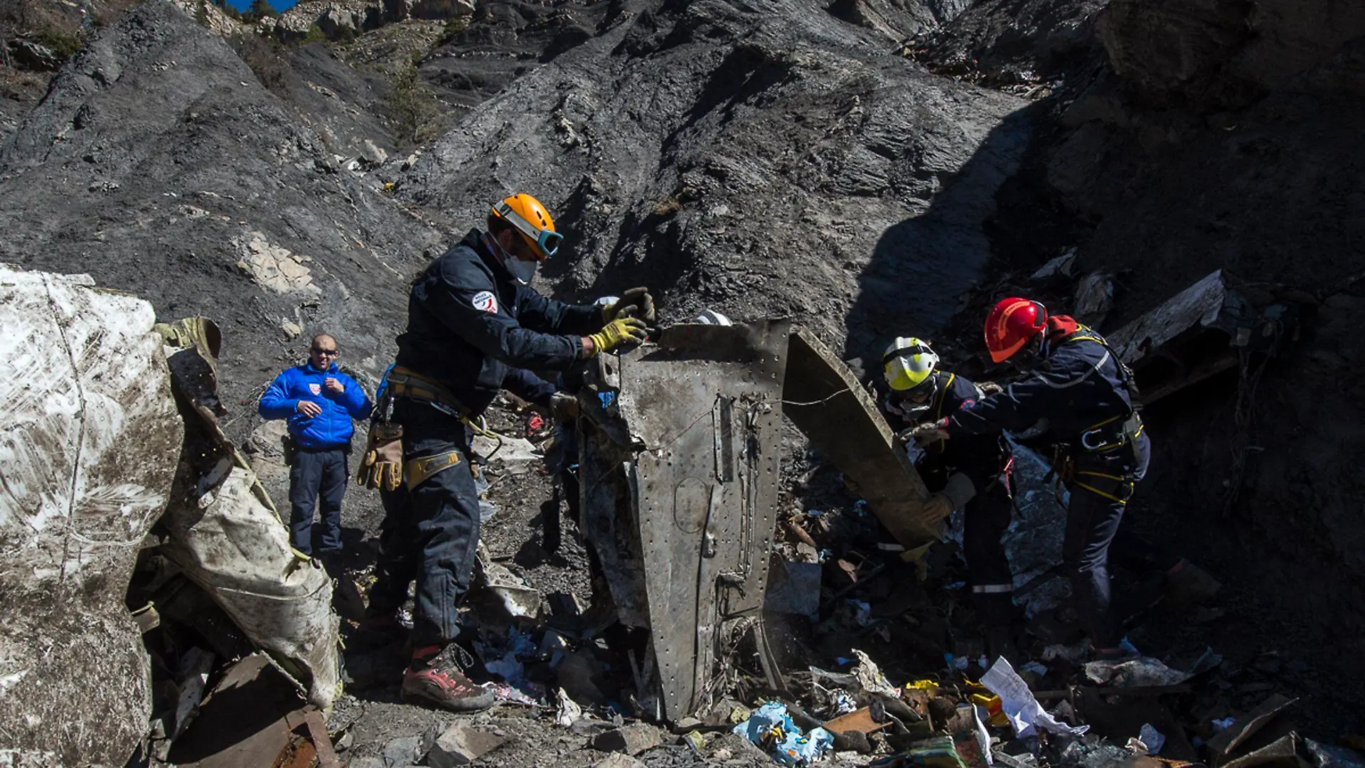 Resuce workers and investigators, seen in this picture made available to the media by the French Interior Ministry April 1, 2015, work near debris from wreckage at the crash site of a Germanwings Airbus A320, near Seyne-les-Alpes. The German pilot, Andreas Lubitz, 27, who crashed a plane in the French Alps last week, killing 150 people, told officials at a Lufthansa training school in 2009 that he had gone through a period of severe depression, the airline said on Tuesday. REUTERS/French Interior Ministry/DICOM/Y. Malenfer/Handout NO ARCHIVES. FOR EDITORIAL USE ONLY. NOT FOR SALE FOR MARKETING OR ADVERTISING CAMPAIGNS. THIS IMAGE HAS BEEN SUPPLIED BY A THIRD PARTY. IT IS DISTRIBUTED, EXACTLY AS RECEIVED BY REUTERS, AS A SERVICE TO CLIENTS