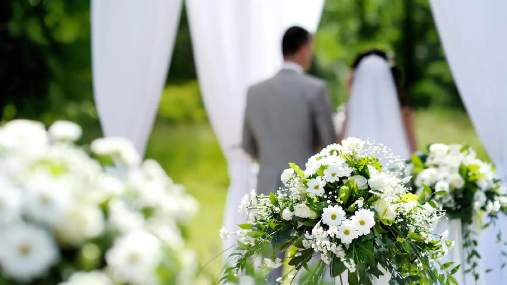 White flowers decorations during outdoor wedding ceremony