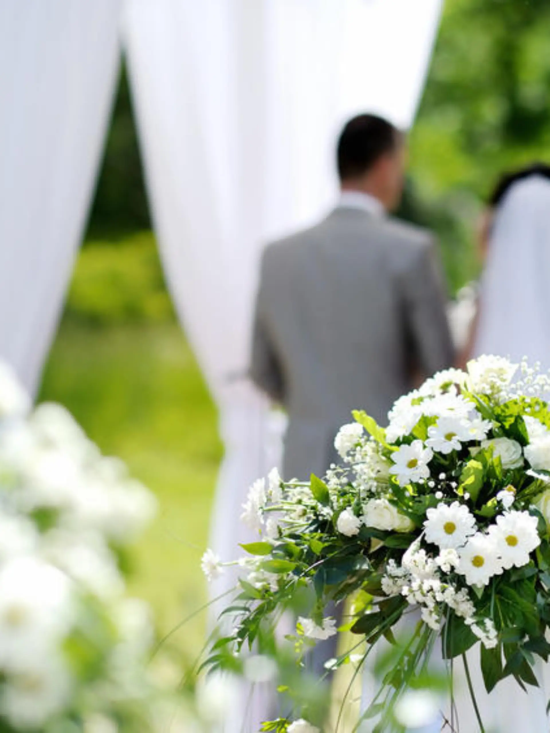 White flowers decorations during outdoor wedding ceremony