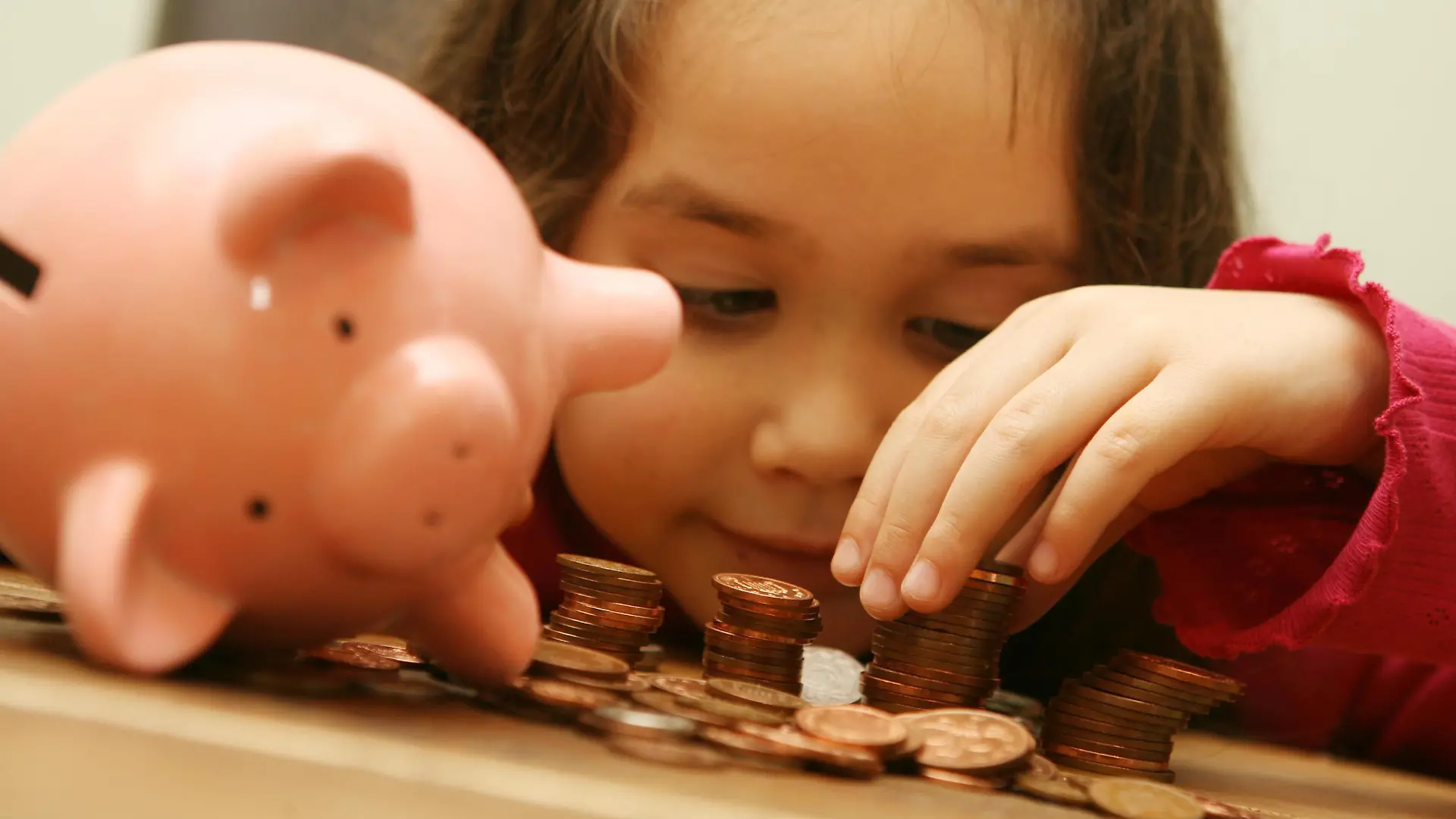 Recession teaches children value of money. Embargoed to 0001 Tuesday September 1, 2009. POSED BY MODEL
File photo dated 16/02/07 of a child counting money from a piggy bank.  Issue date: Monday August 31, 2009. Two-thirds of parents think the economic downturn has helped them to teach their children about the value of money, research showed today. Two out of three parents with seven-year-olds said the recession had helped their children understand that "money did not grow on trees", while a third thought it would make them more responsible when handling their own cash. See PA story MONEY Children. Photo credit should read: Anthony Devlin/PA Wire URN:7758658