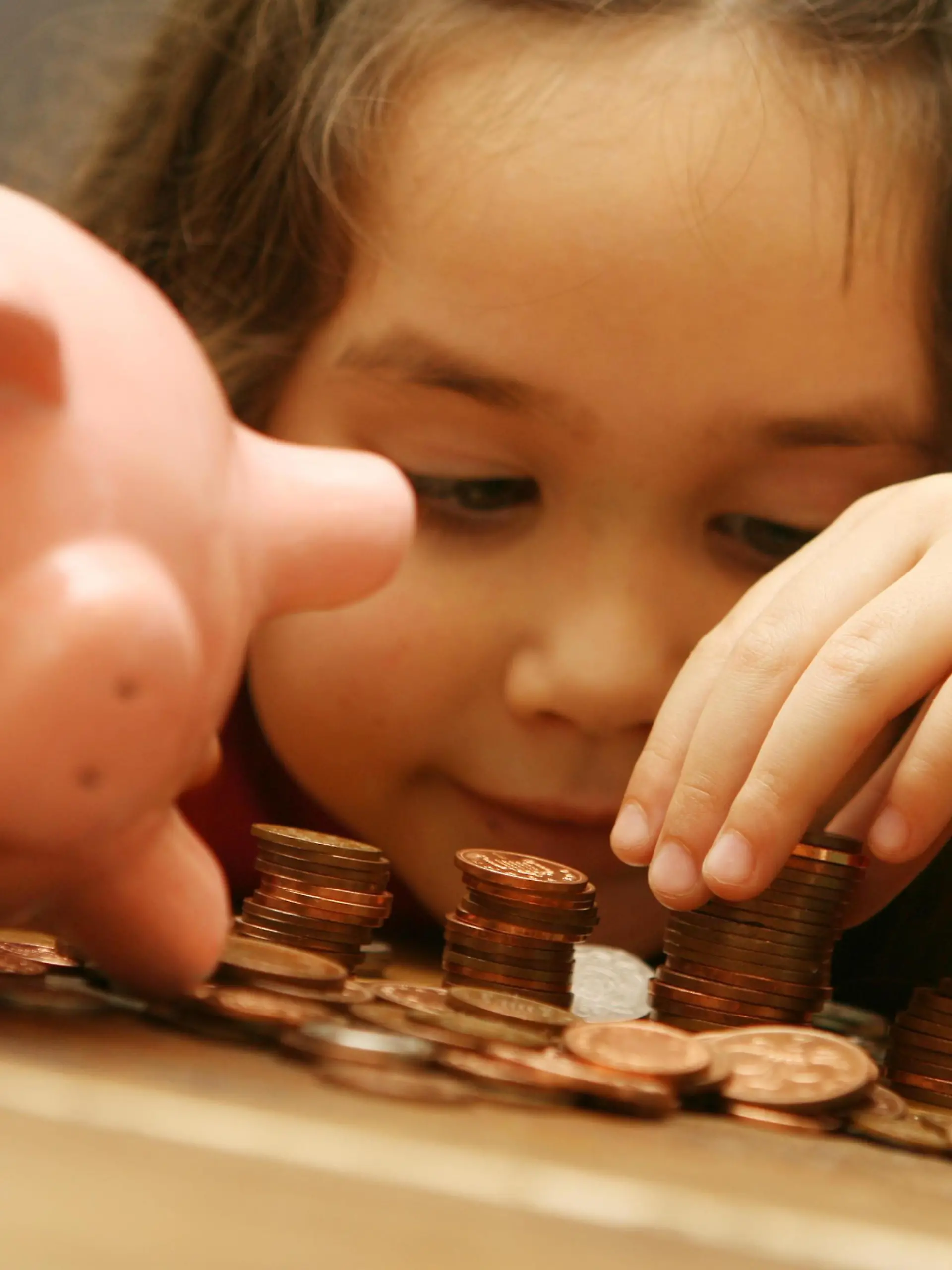 Recession teaches children value of money. Embargoed to 0001 Tuesday September 1, 2009. POSED BY MODEL
File photo dated 16/02/07 of a child counting money from a piggy bank.  Issue date: Monday August 31, 2009. Two-thirds of parents think the economic downturn has helped them to teach their children about the value of money, research showed today. Two out of three parents with seven-year-olds said the recession had helped their children understand that "money did not grow on trees", while a third thought it would make them more responsible when handling their own cash. See PA story MONEY Children. Photo credit should read: Anthony Devlin/PA Wire URN:7758658