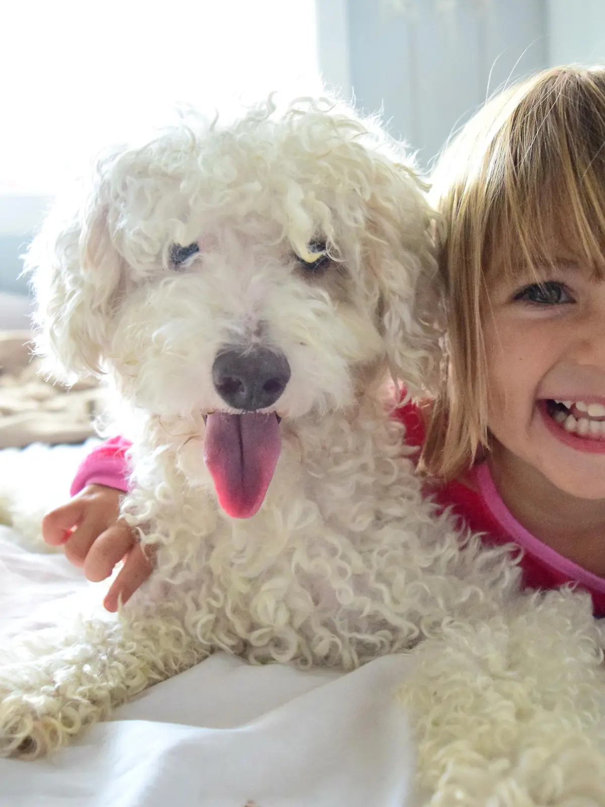 Mädchen kuschelt mit Hund