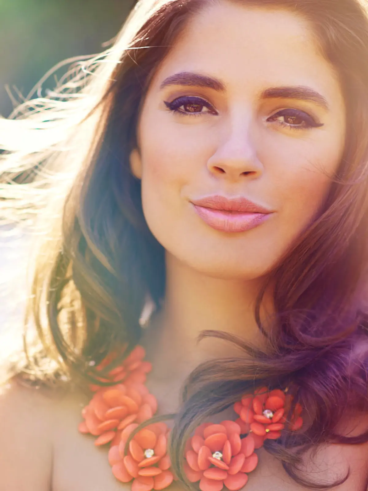 Portrait of an elegantly dressed gorgeous young woman outdoors