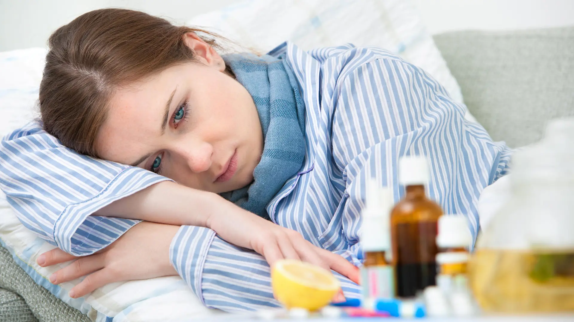 Sick woman lying in bed with high fever. Cold, flu, fever and migraine