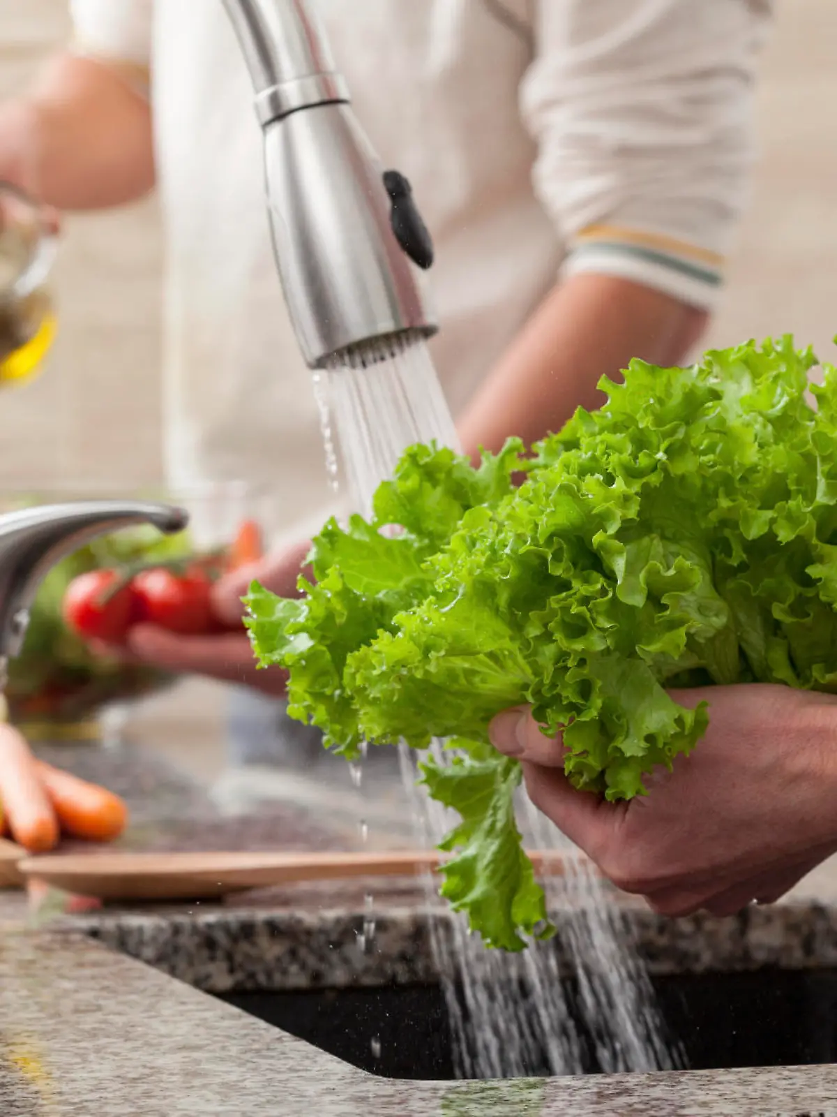 Washing fresh vegetables for a salad with an alive oil