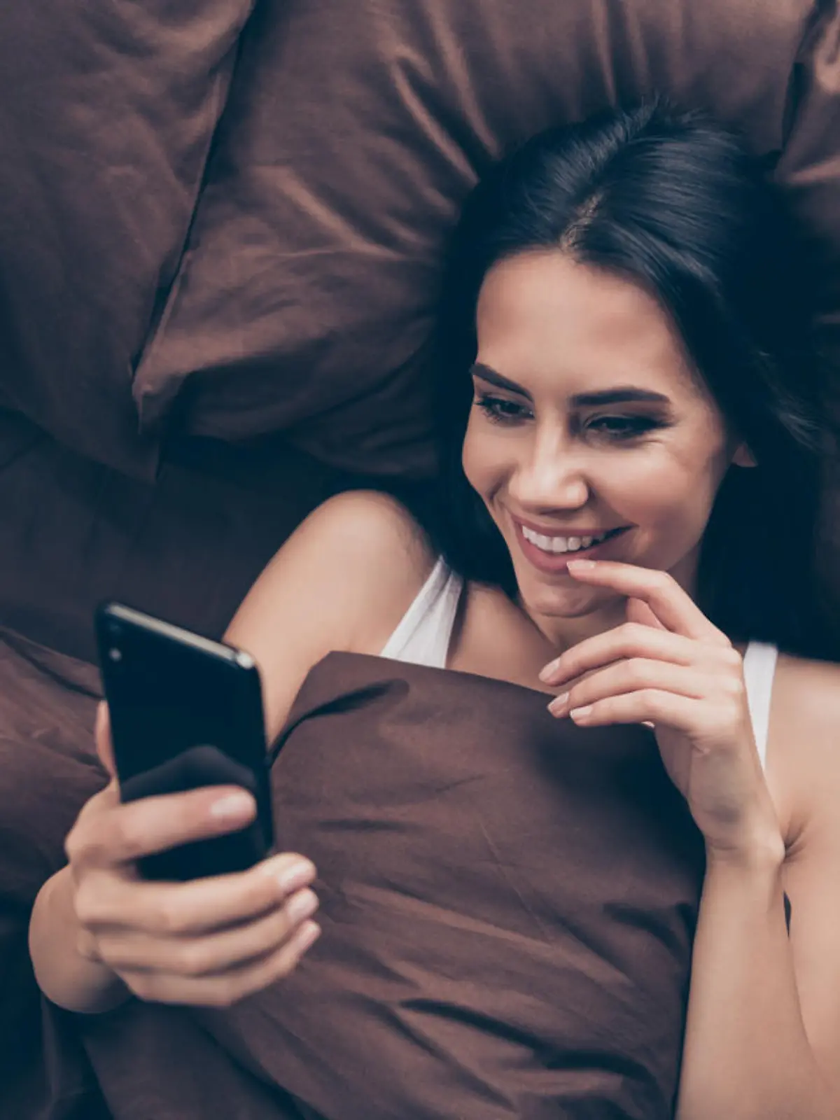 Top above high angle view close-up portrait of her she nice attractive, lovely flirt charming cute cheerful cheery girl using gadget sending photos lying in bed in room flat house indoors