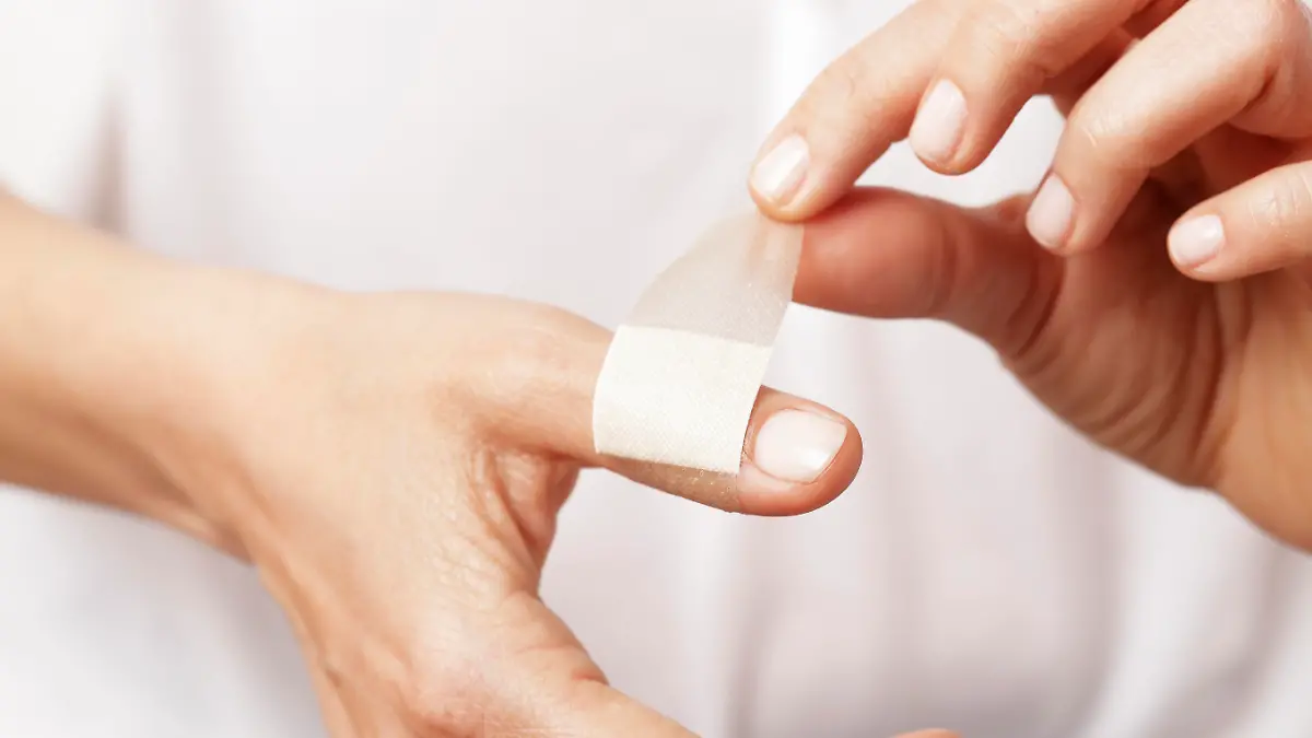 Forefinger of a woman hand with a band aid