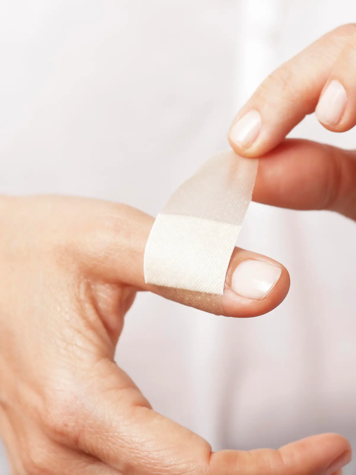 Forefinger of a woman hand with a band aid