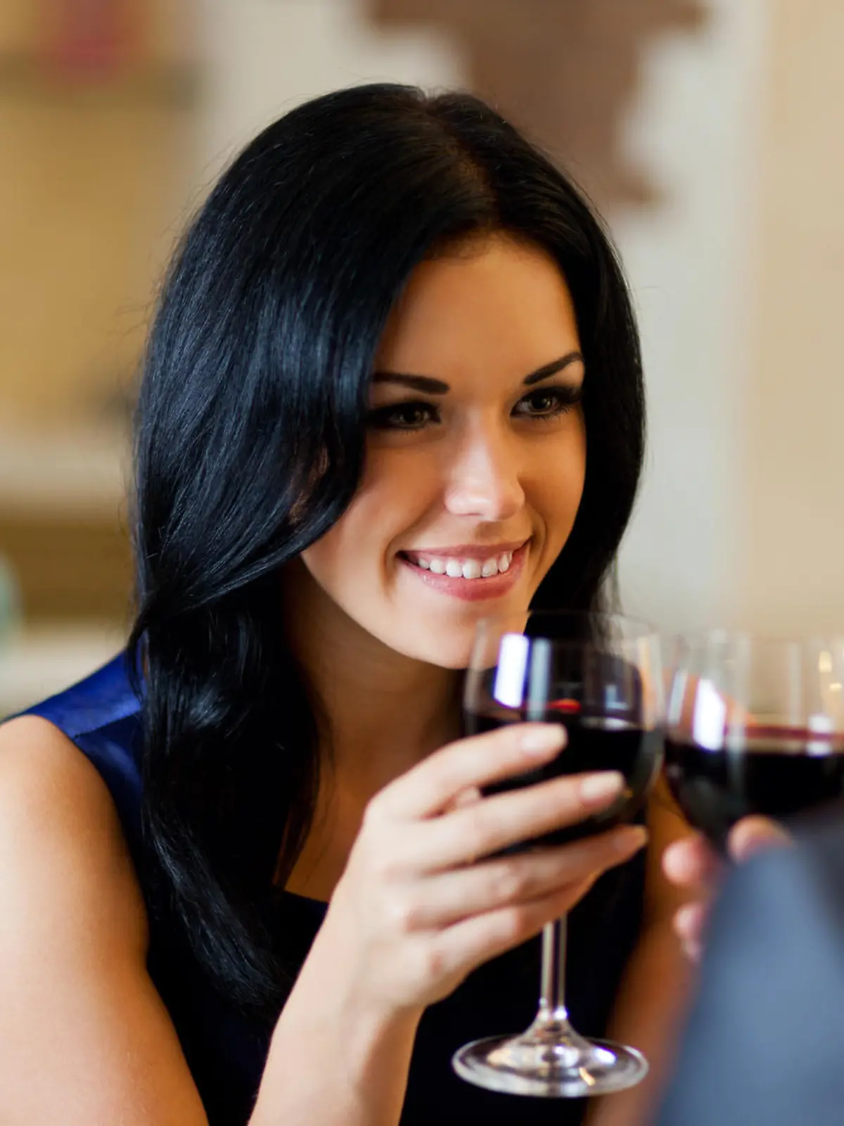 Young happy couple romantic date drink glass of red wine at restaurant, celebrating valentine day