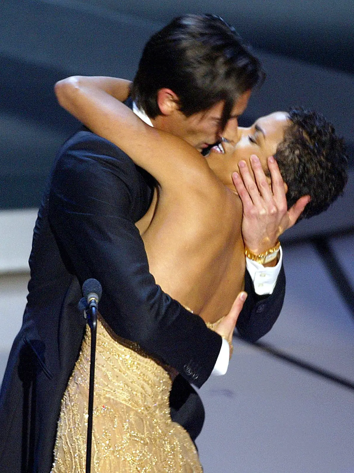 Actor Adrien Brody kisses presenter Actress Halle Berry as he accepts his Oscar for Performance by an actor in a leading role for his role in "The Pianist" during the 75th Academy Awards at the Kodak Theatre in Hollywood, California, 23 March, 2003.   (Photo credit should read TIMOTHY A. CLARY/AFP via Getty Images)