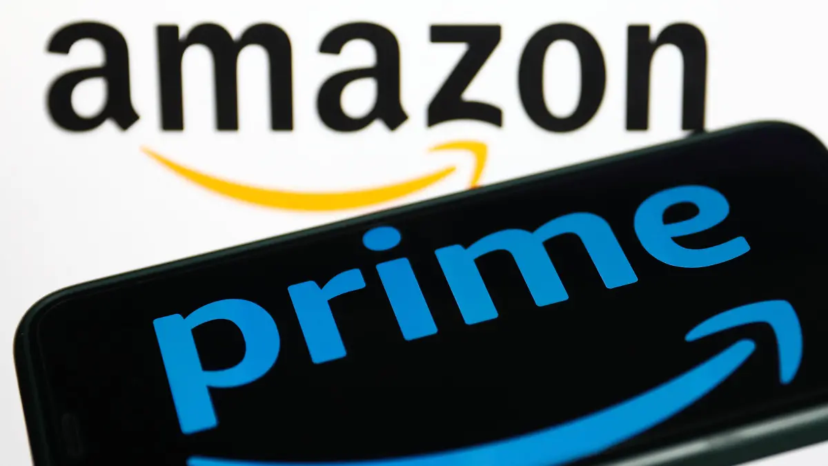 Prime logo displayed on a phone screen and Amazon logo displayed on a screen in the background are seen in this illustration photo taken in Krakow, Poland on January 19, 2023. (Photo by Jakub Porzycki/NurPhoto)