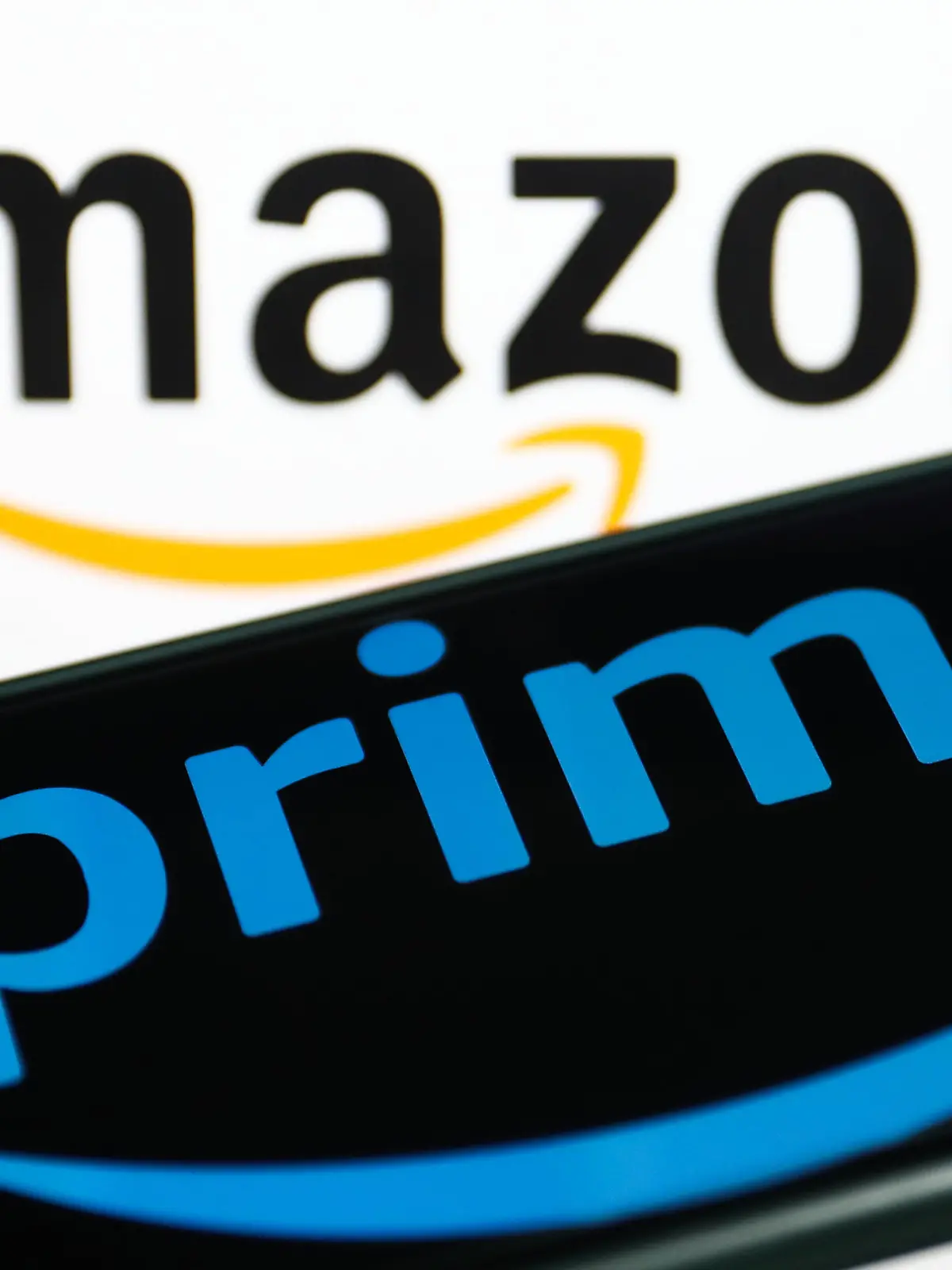 Prime logo displayed on a phone screen and Amazon logo displayed on a screen in the background are seen in this illustration photo taken in Krakow, Poland on January 19, 2023. (Photo by Jakub Porzycki/NurPhoto)