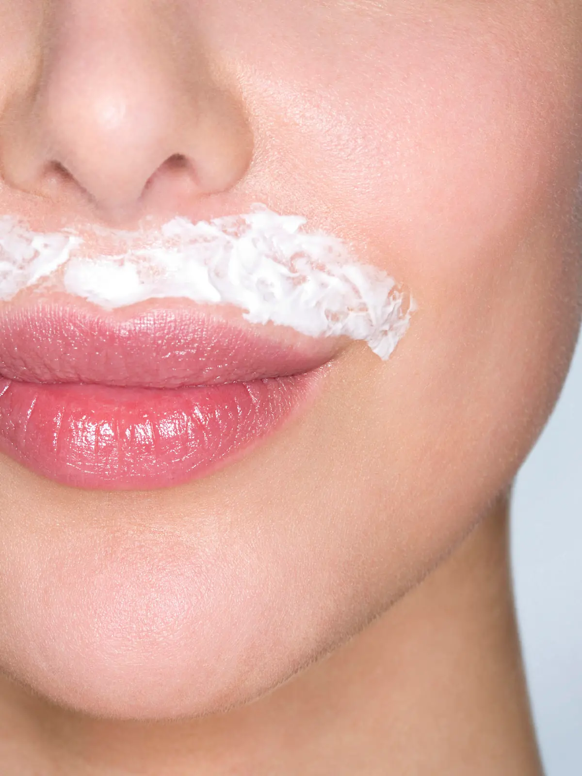 Woman bleaching facial hair