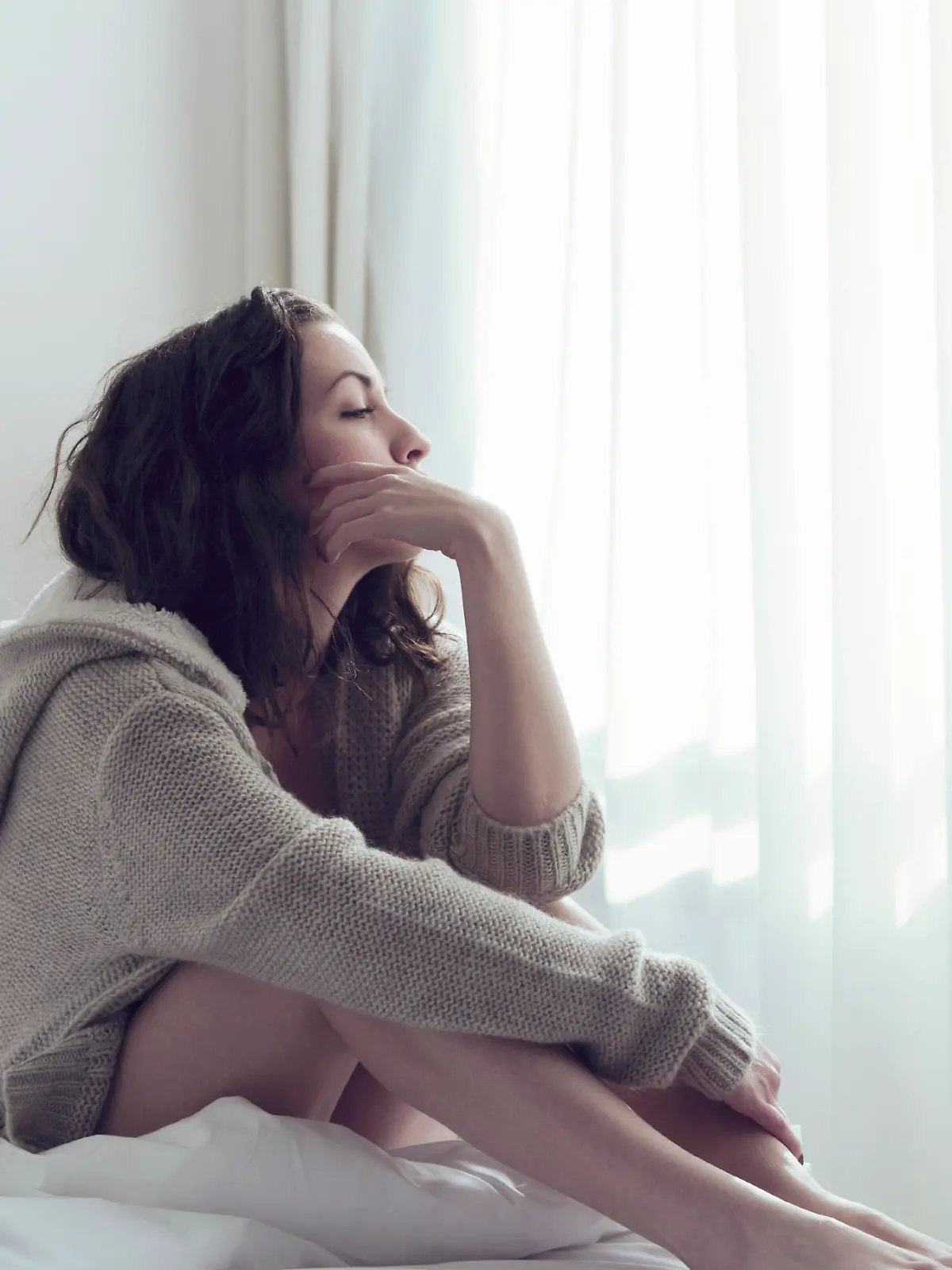 Woman sitting relaxed in bed