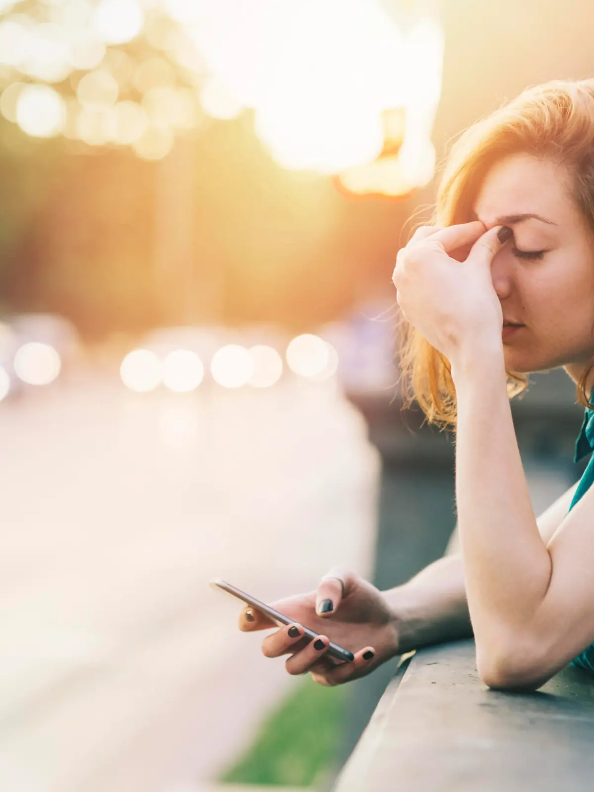 Teenage girl breaking up with her boyfriend while sitting on a bridge near big boulevard. Casual clothing with shirt and jeans.