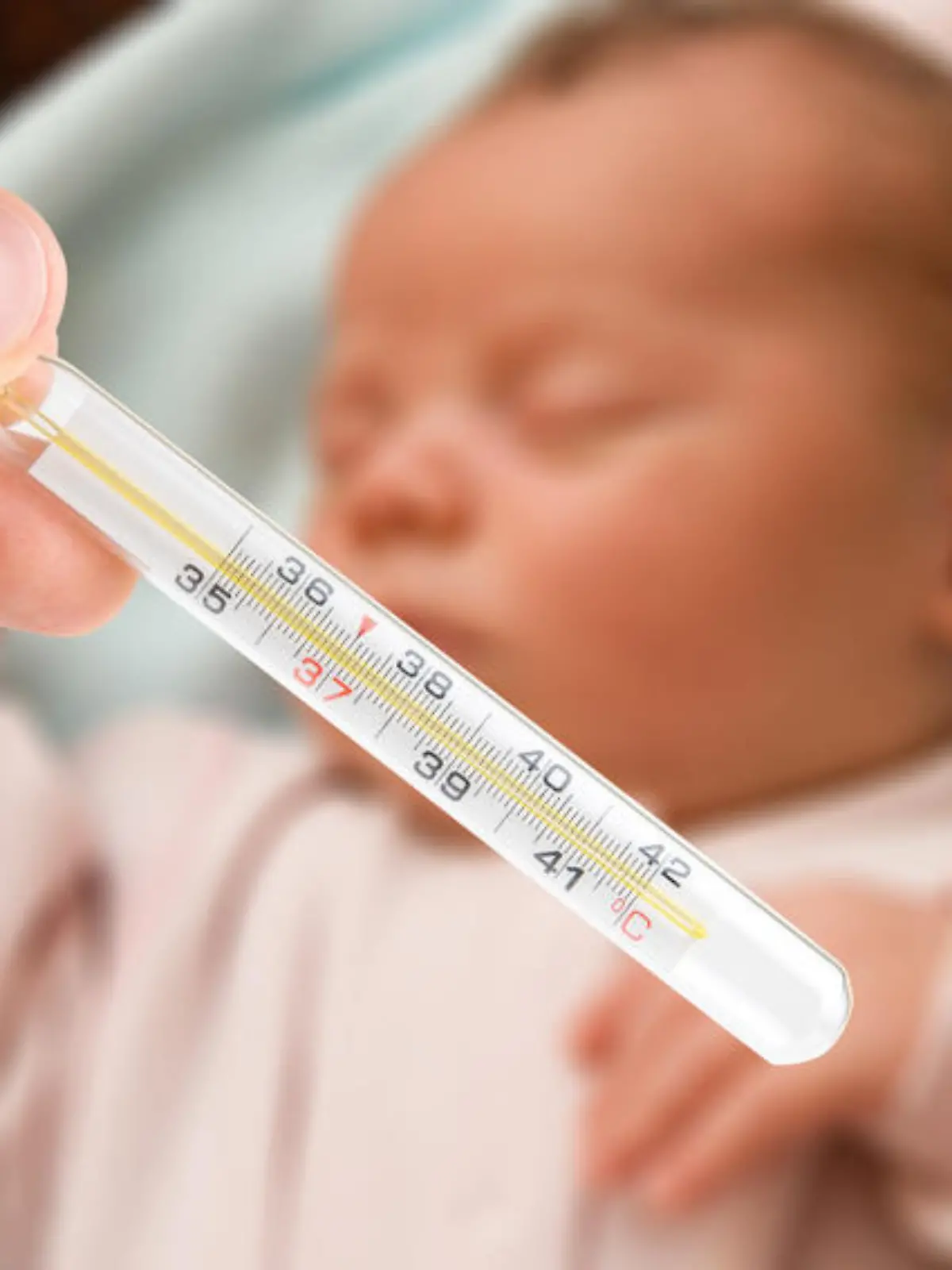 Mom check the temperature of sleeping baby