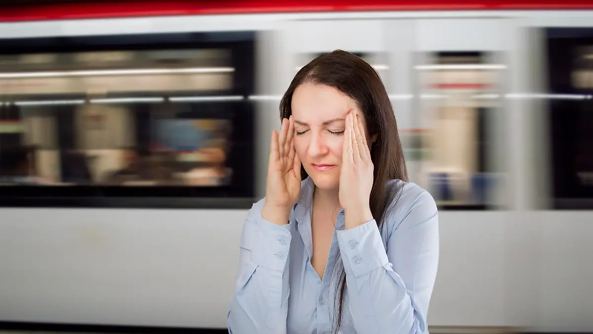 woman with headache at the underground station