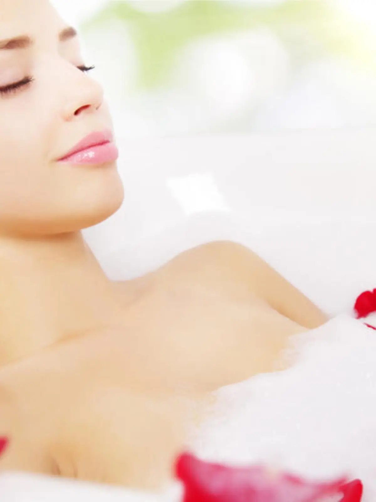girl relaxing in bathtub on light background