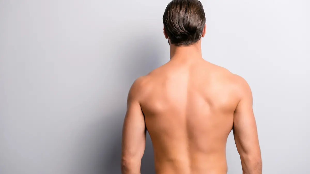 Rear back behind view photo of strong muscular handsome attractive stunning confident ideal perfect sportsman isolated on gray background copyspace