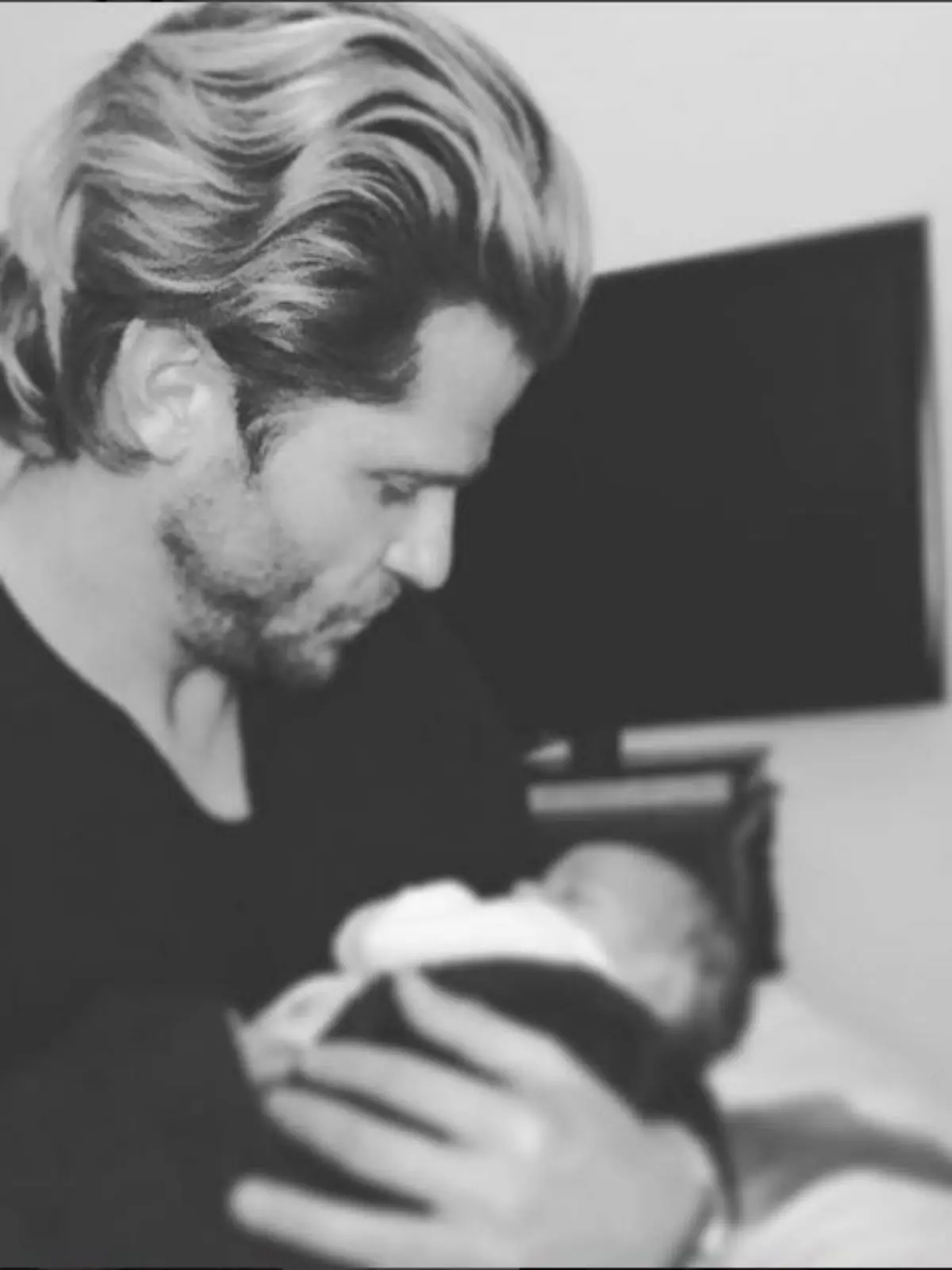 Paul Janke mit dem Baby seines Freundes auf dem Arm