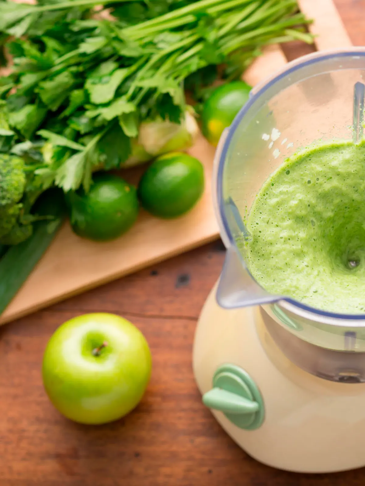 Green smoothie in a blender and ingredients, view from above