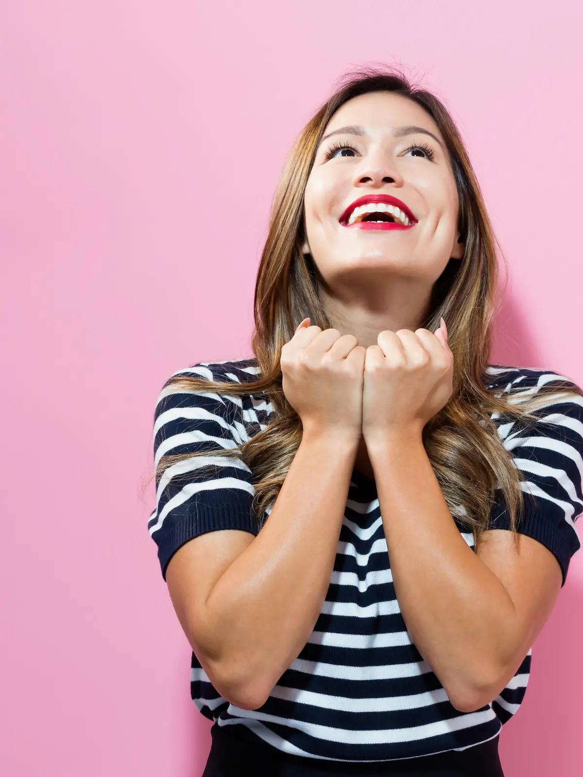 Successful young woman on a pink background