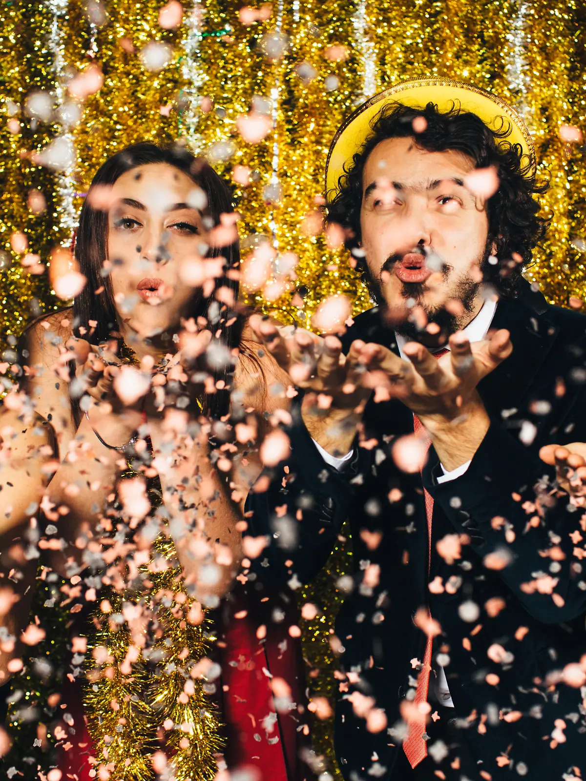 Friends blowing confetti on New Year's Eve - 2016.