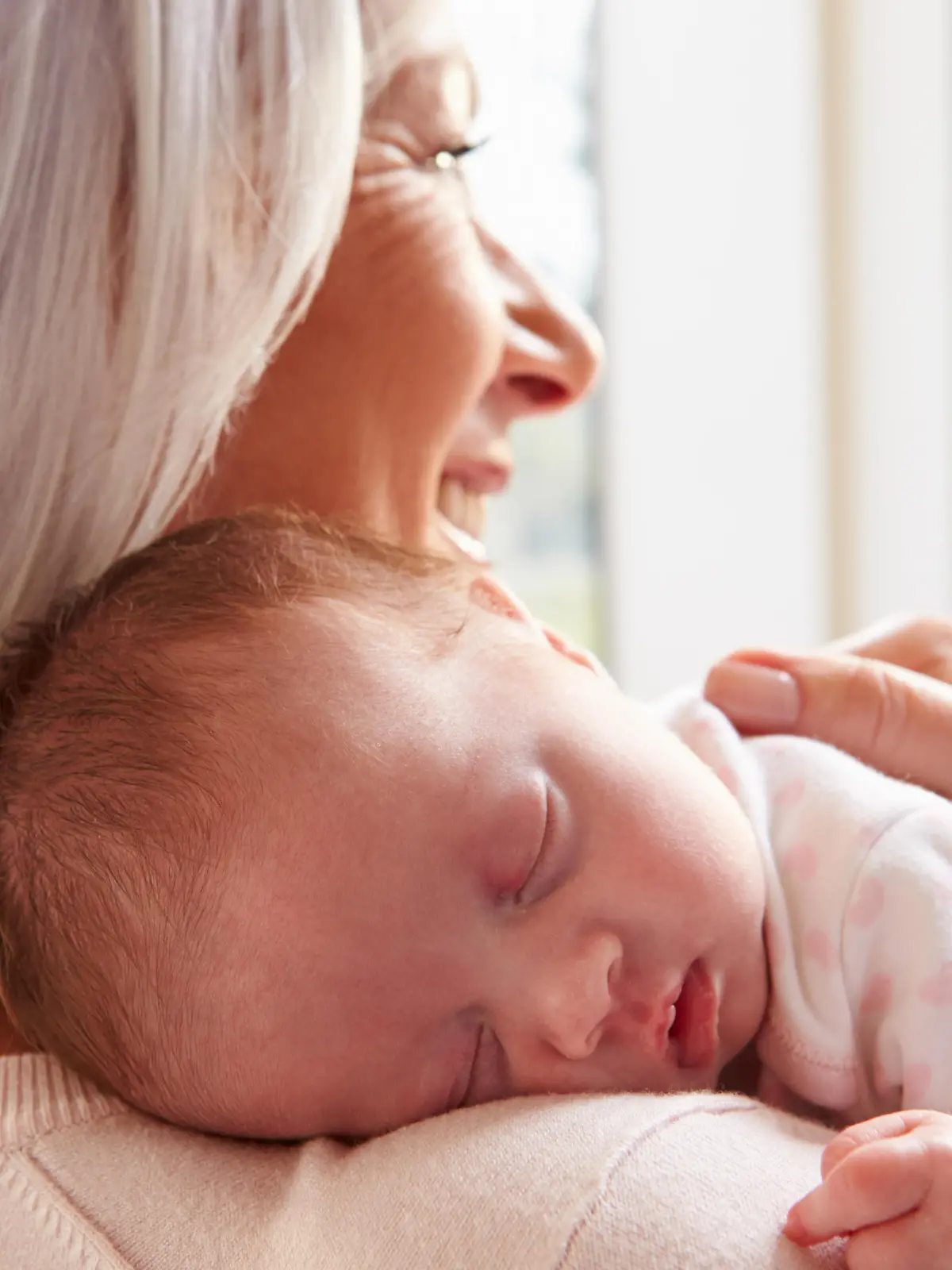 Grandmother Holding Sleeping Newborn Baby Granddaughter