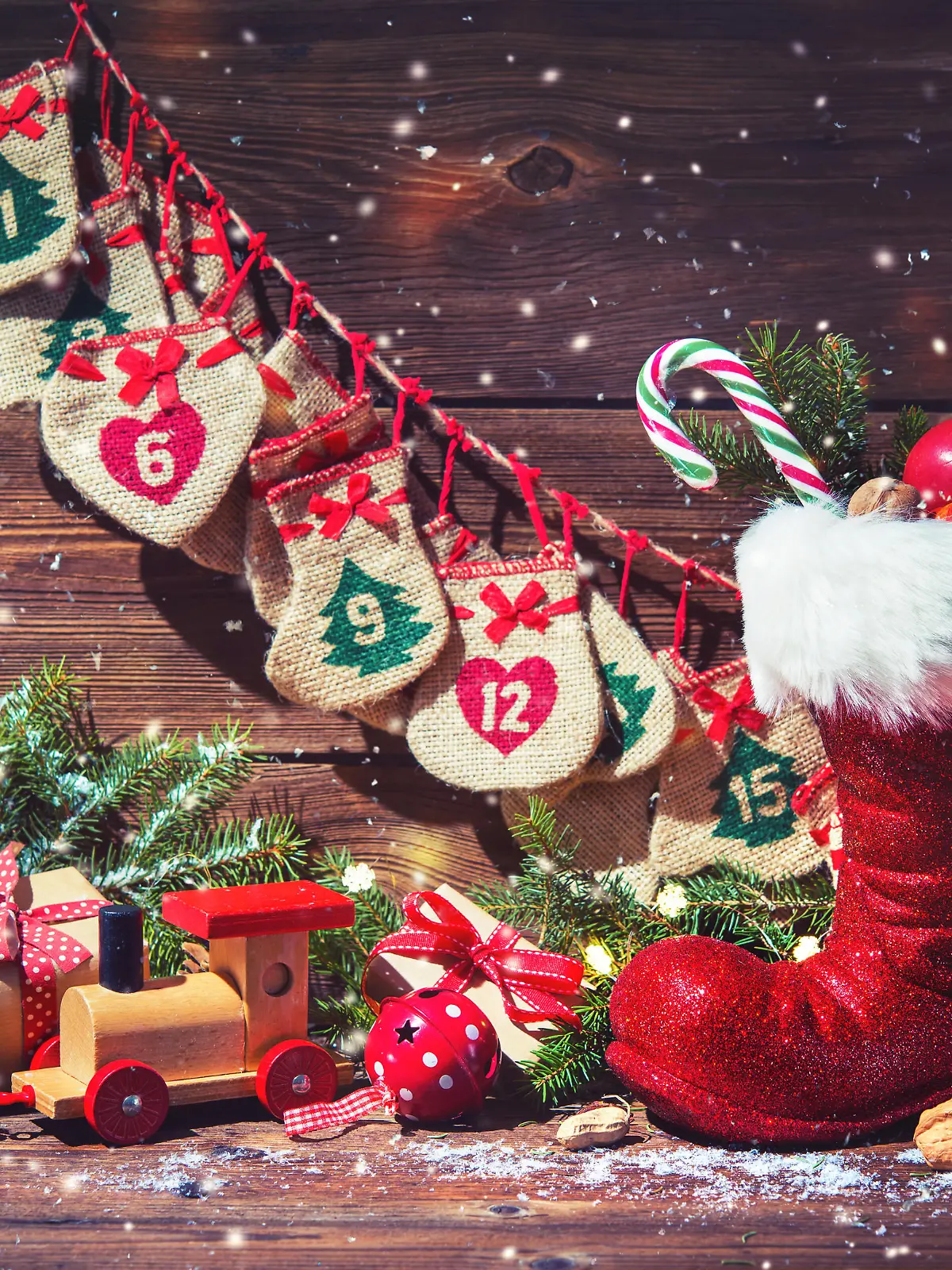Christmas background. Advent calendar and Santa's shoe with gifts on rustic wooden background