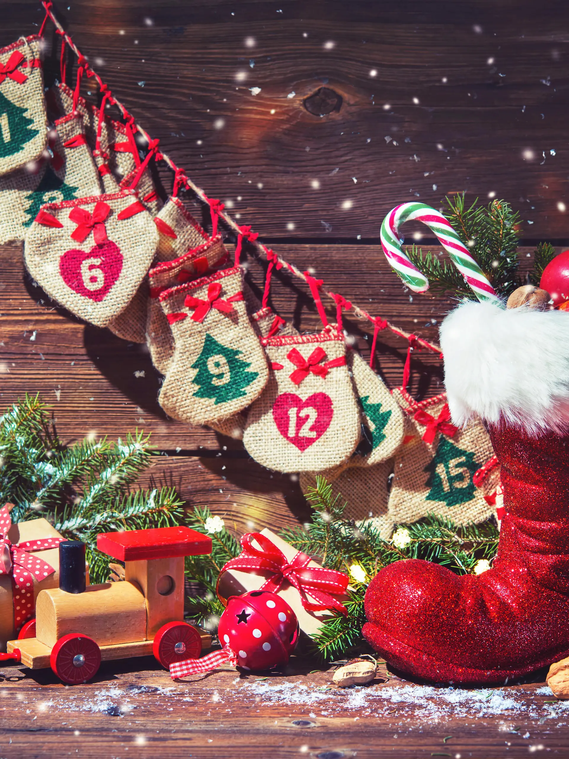 Christmas background. Advent calendar and Santa's shoe with gifts on rustic wooden background