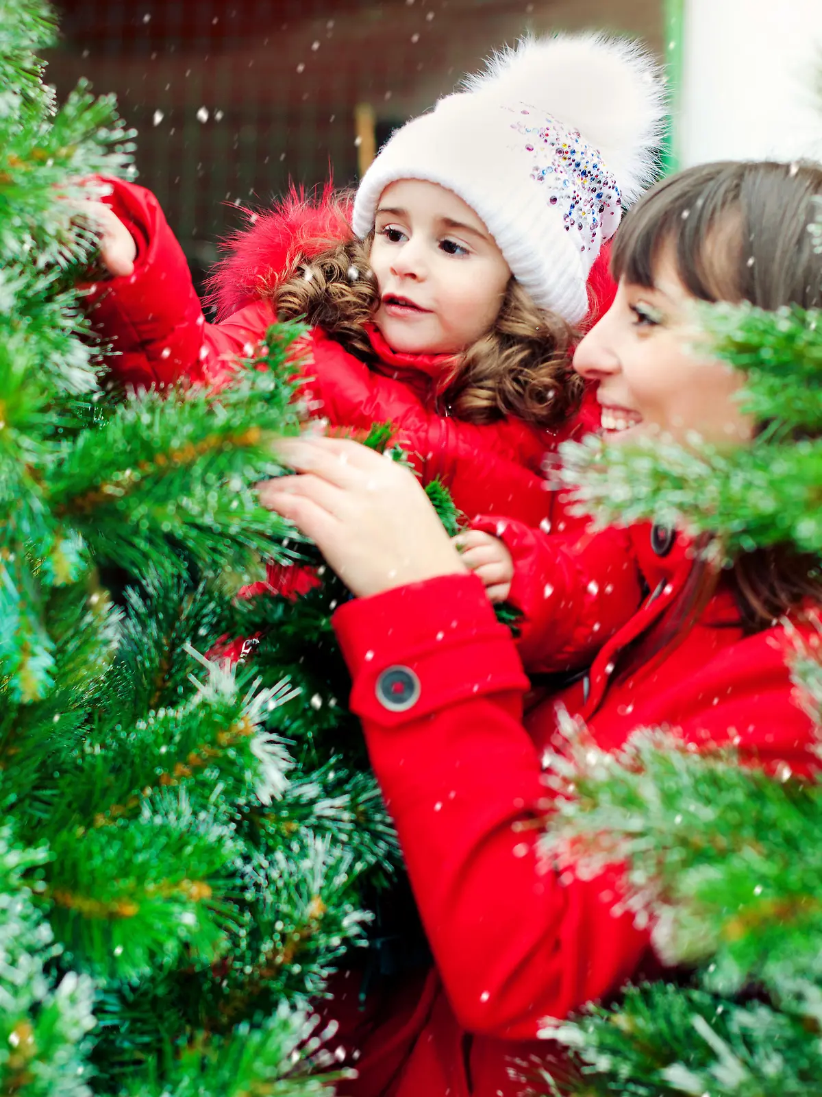 Mother and daughter choosing Christmas tree