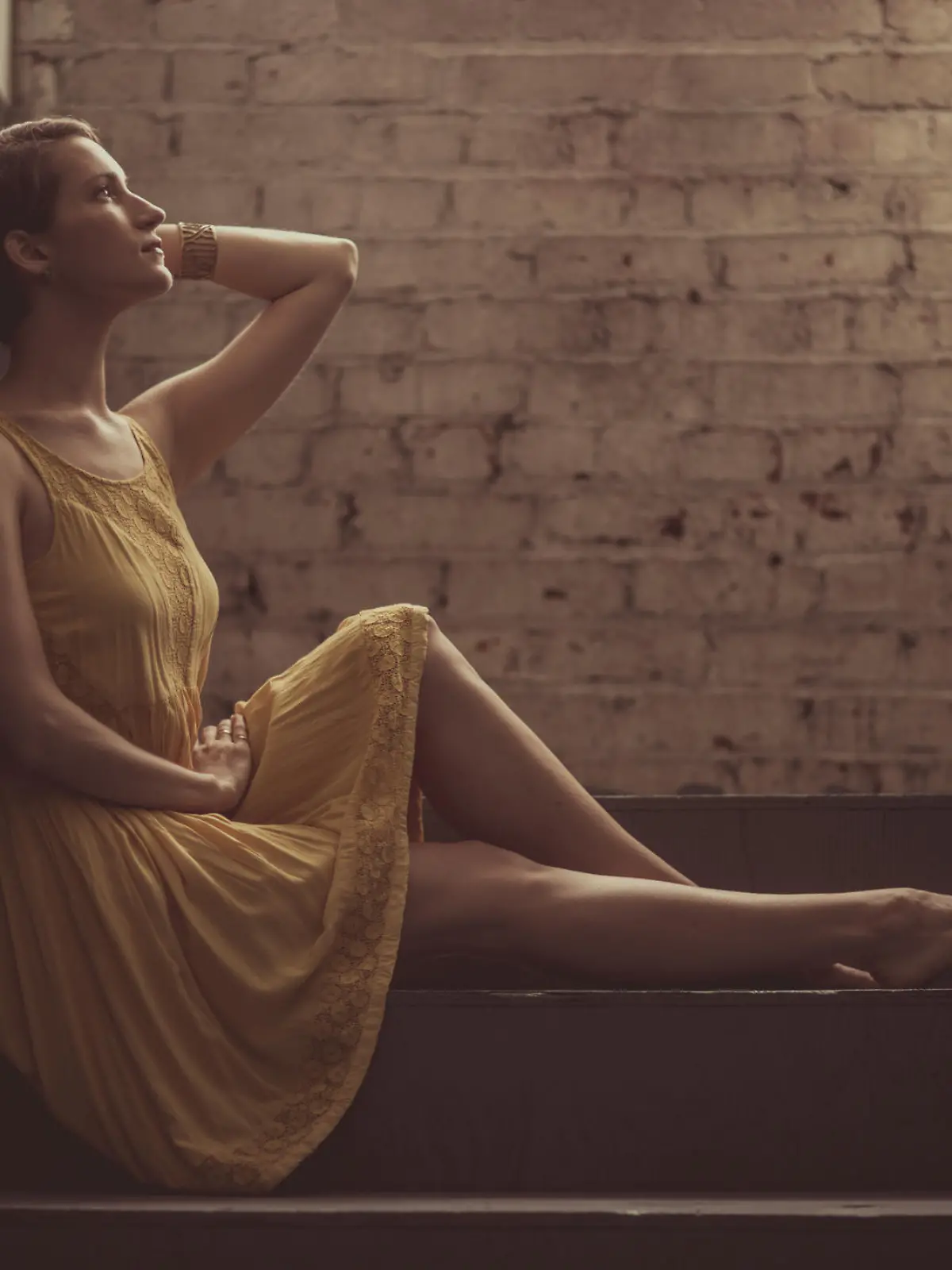 A beautiful woman sitting alone in a hallway (stock image)