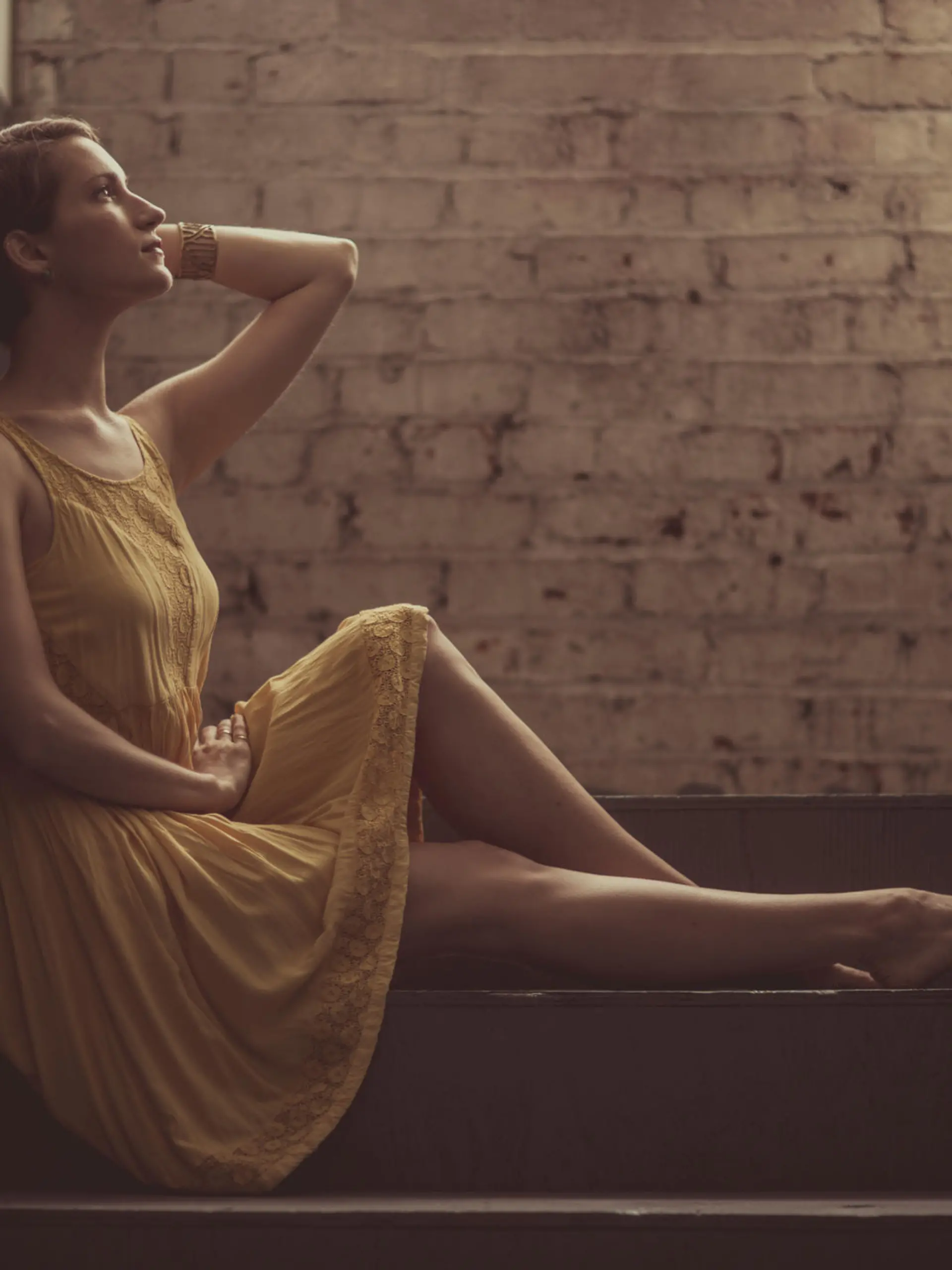 A beautiful woman sitting alone in a hallway (stock image)
