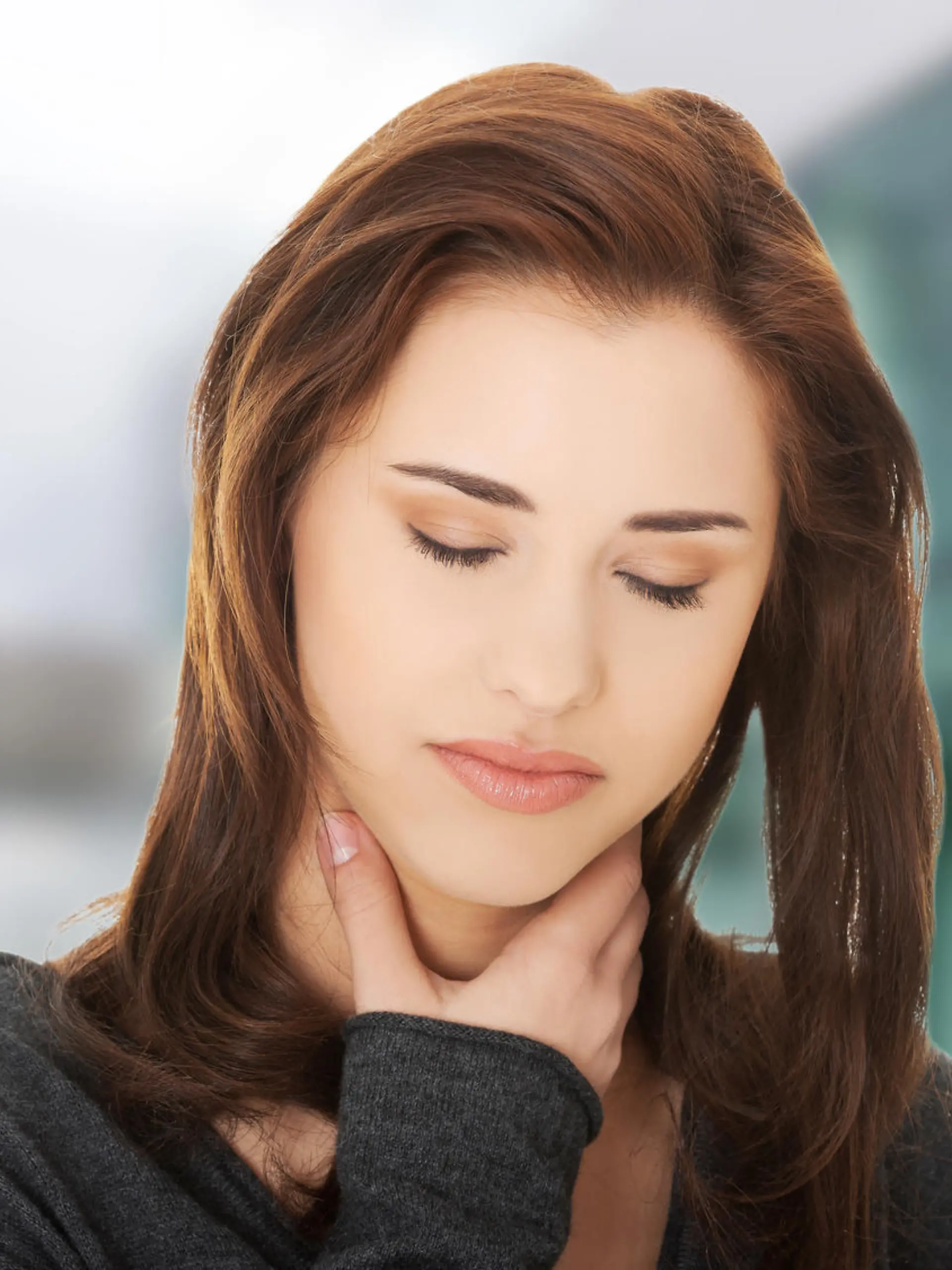 Charming young woman with terrible throat pain