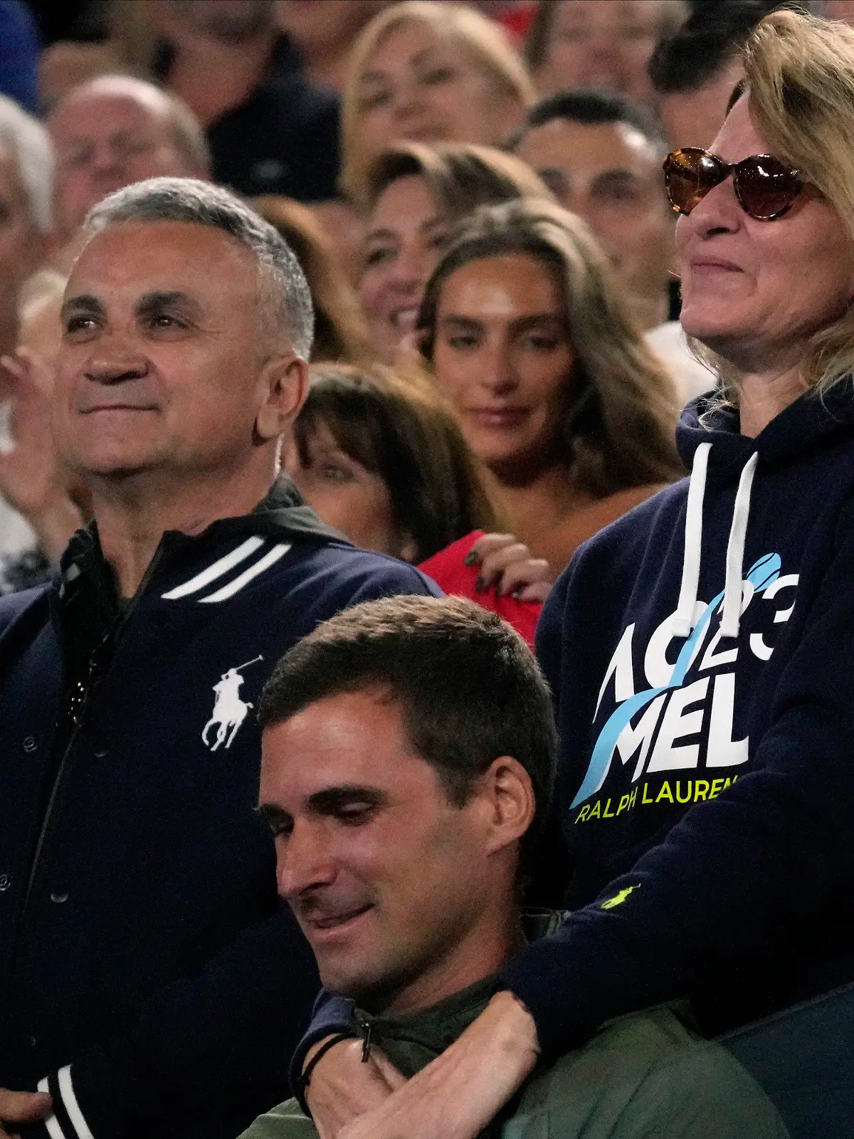 The parents of Novak Djokovic of Serbia, father Srdjan and mother Dijana react during his post match speech following his win over Andrey Rublev of Russia at the Australian Open tennis championship in Melbourne, Australia, Wednesday, Jan. 25, 2023. (AP Photo/Dita Alangkara)
