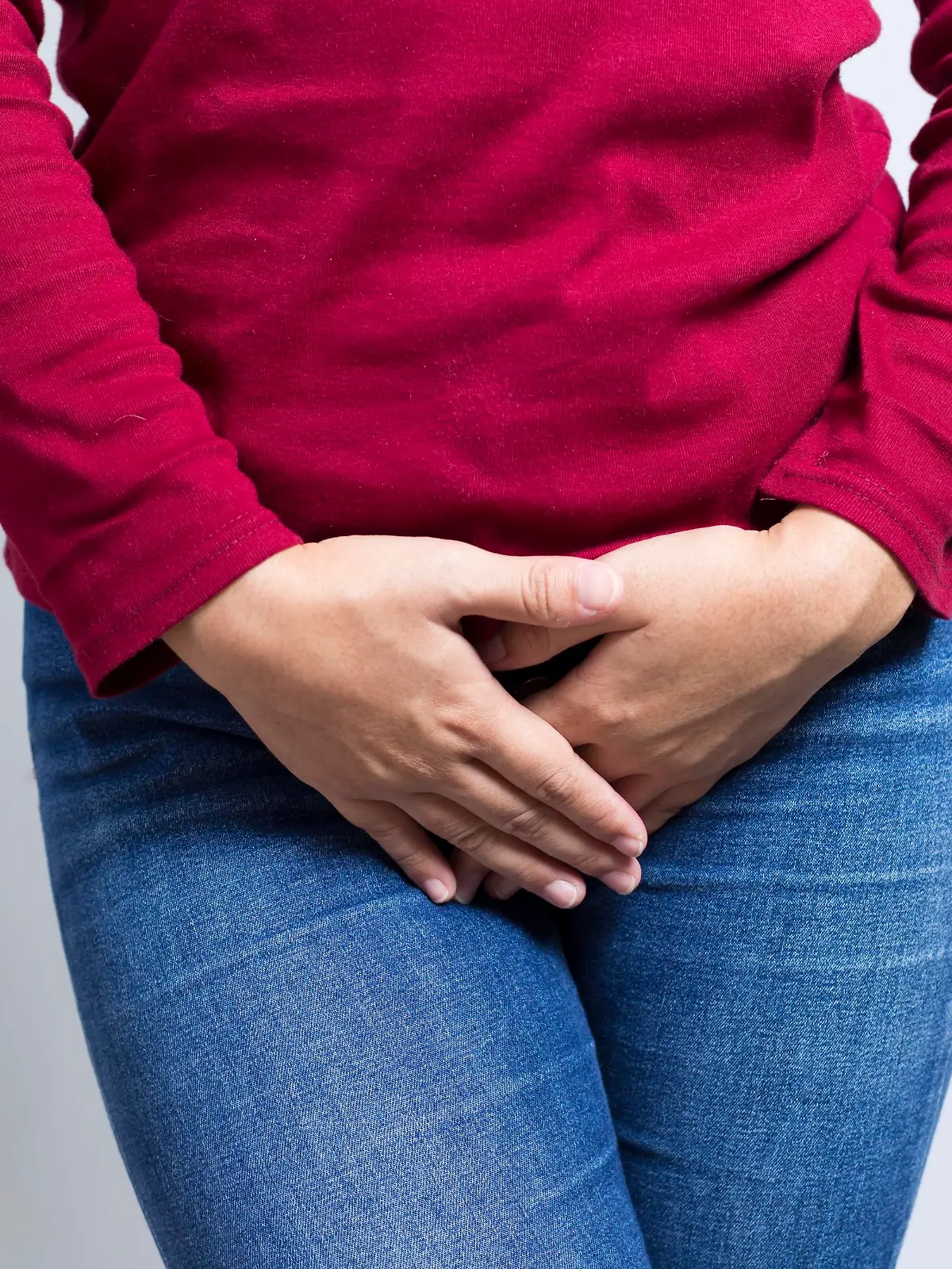 Woman with Hands Holding her Crotch Isolated in a White Background