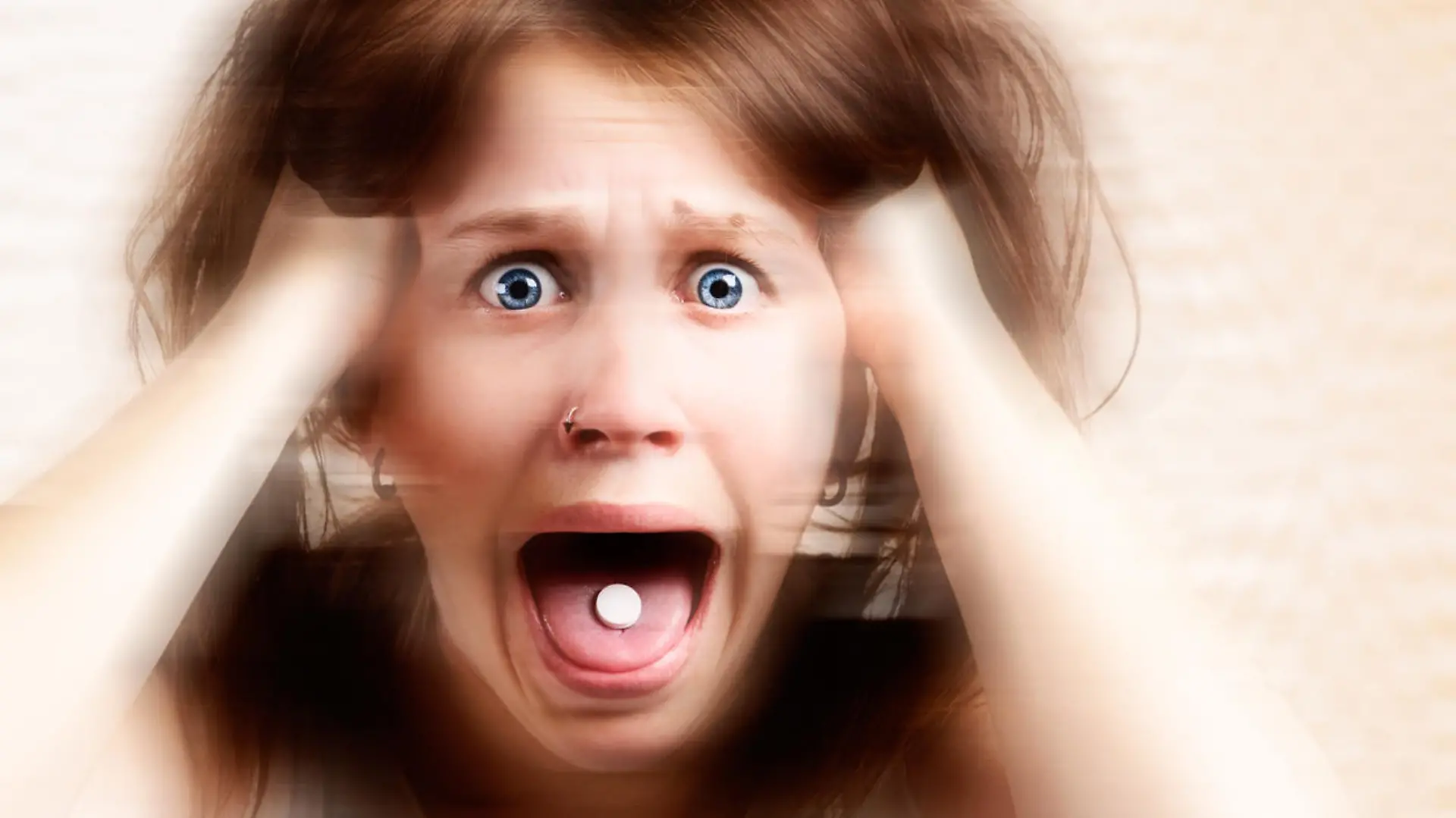 A distorted portrait of a terrified young woman with a pill in her mouth, screaming and tearing her hair out. Symbolizes the horrific results of drug abuse.