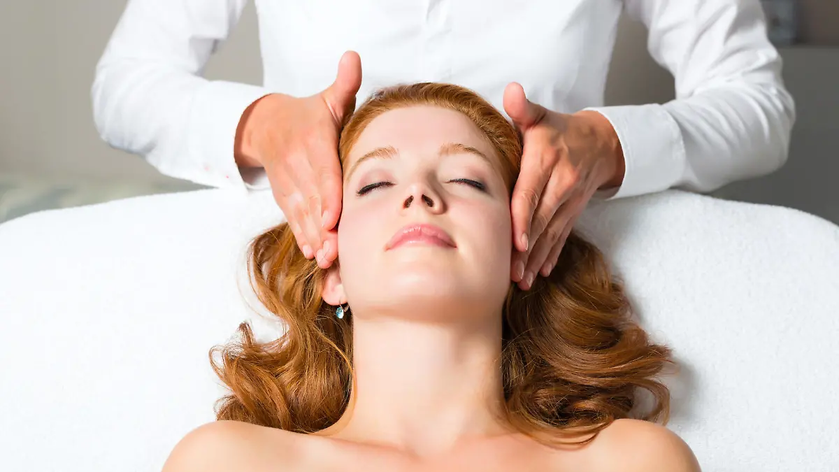 Wellness - woman getting massage in Spa, it is a massage for the head or face