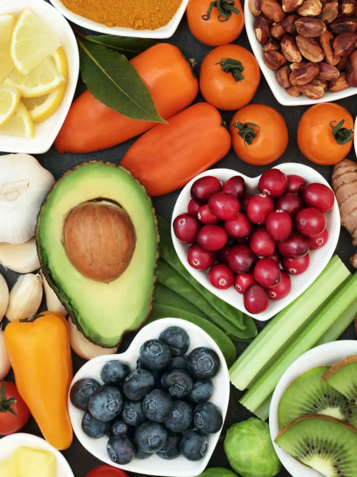 Health food for fitness concept with fresh fruit, vegetables, pulses, herbs, spices, nuts, grains and pulses. High in anthocyanins, antioxidants,smart carbohydrates, omega 3 fatty acids,  minerals and vitamins.