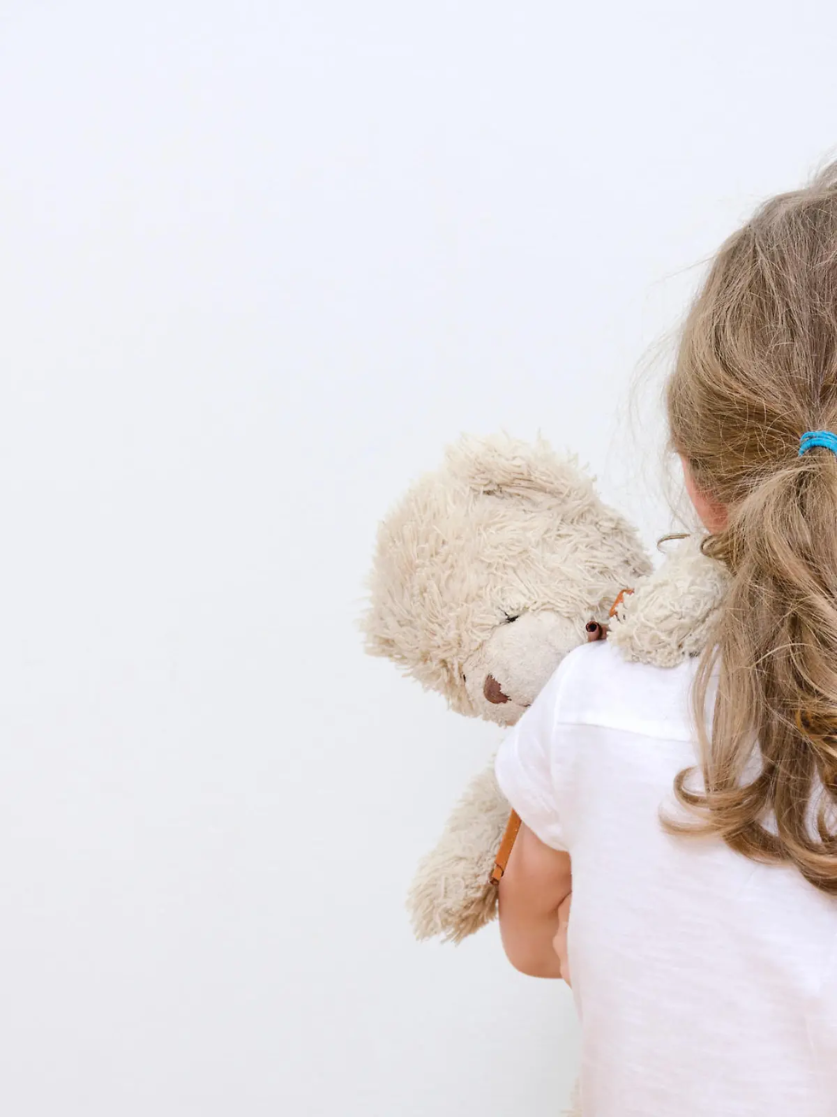Little girl crying in the corner. Domestic violence concept.