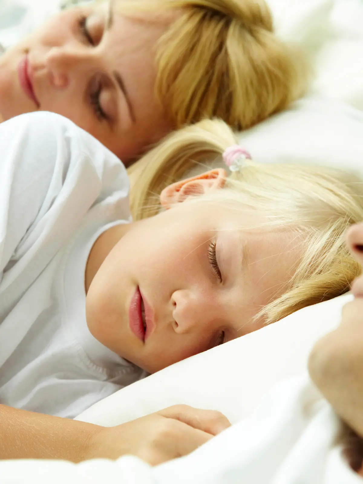 Portrait of calm family sleeping with focus on cute child